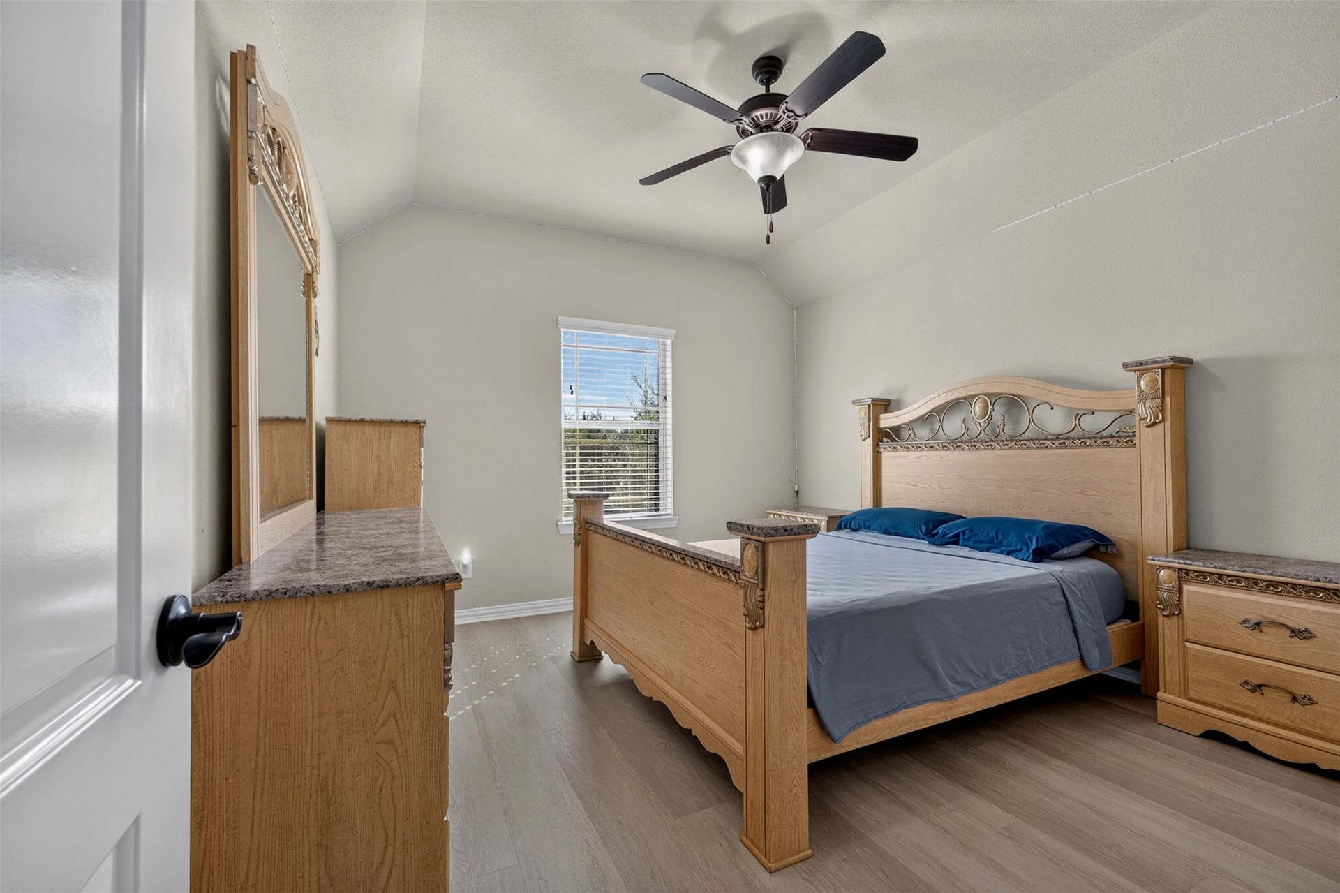 27818 Burchfield Grove Lane, Katy, TX 77494 This bedroom offers a comfortable retreat with a vaulted ceiling, ceiling fan, and light-toned flooring. A window brings in daylight, while the spacious layout accommodates a full bedroom furniture arrangement.