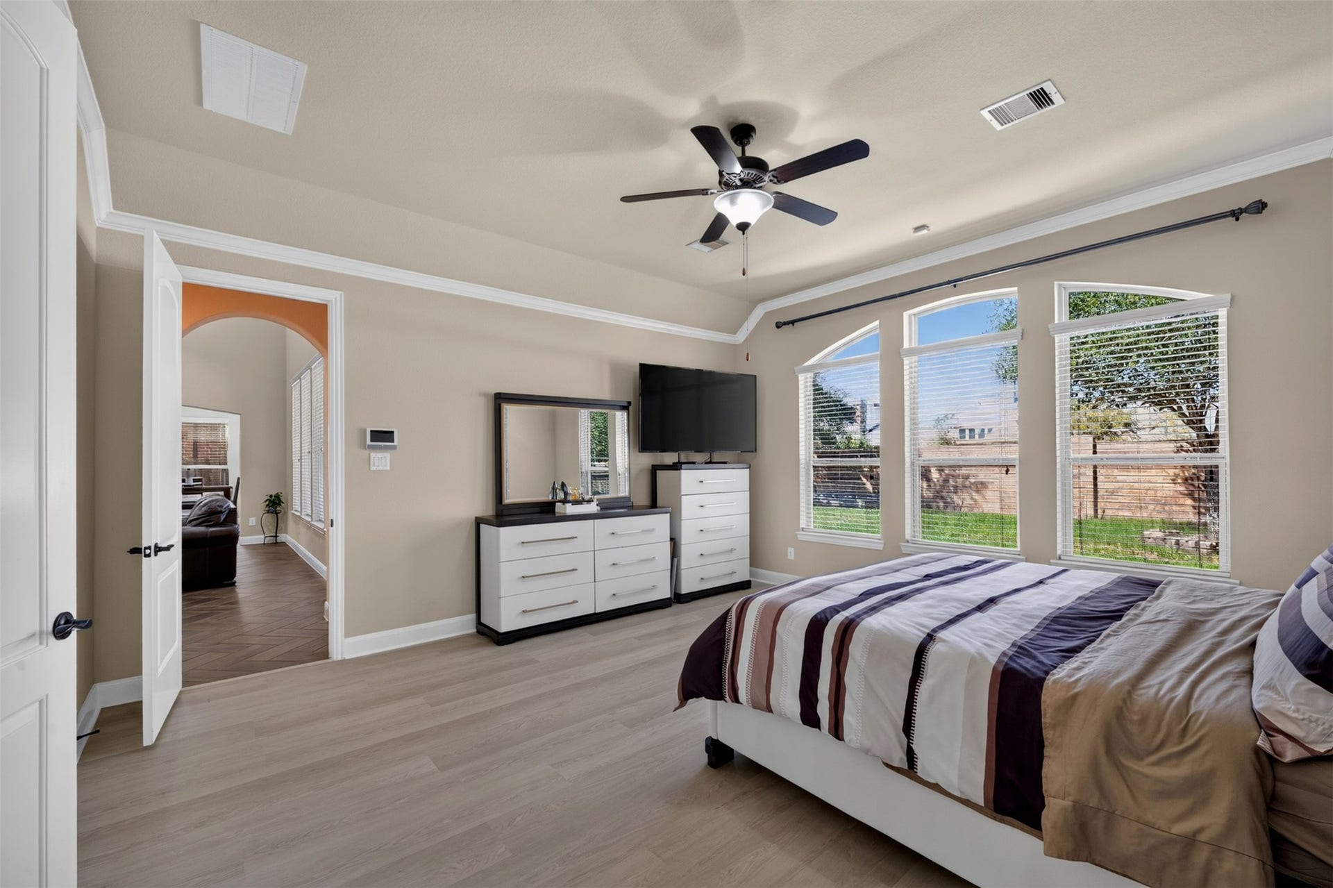27818 Burchfield Grove Lane, Katy, TX 77494 The light wood-look flooring complements the warm wall color while the space offers flexibility for additional furniture.