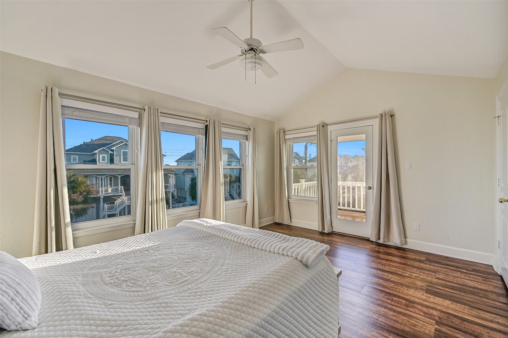 13414 Binnacle Way, Galveston, TX 77554 Notice the walls of windows that bring in abundant natural light. The door across the room provides access to the covered deck.