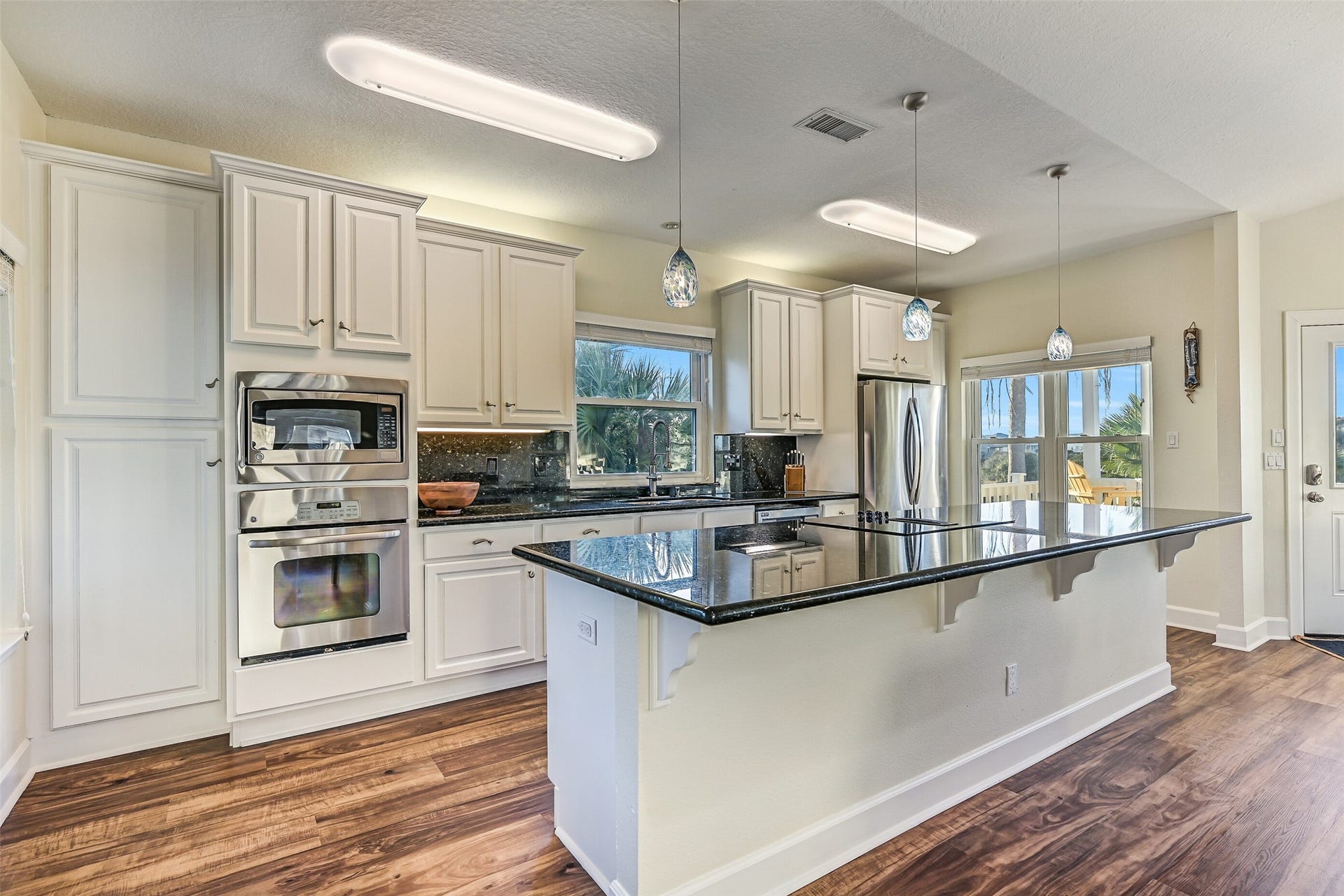 13414 Binnacle Way, Galveston, TX 77554 Perfect for cooking and entertaining, the kitchen showcases stainless steel appliances, a generous island with electric cooktop, and extensive cabinetry.