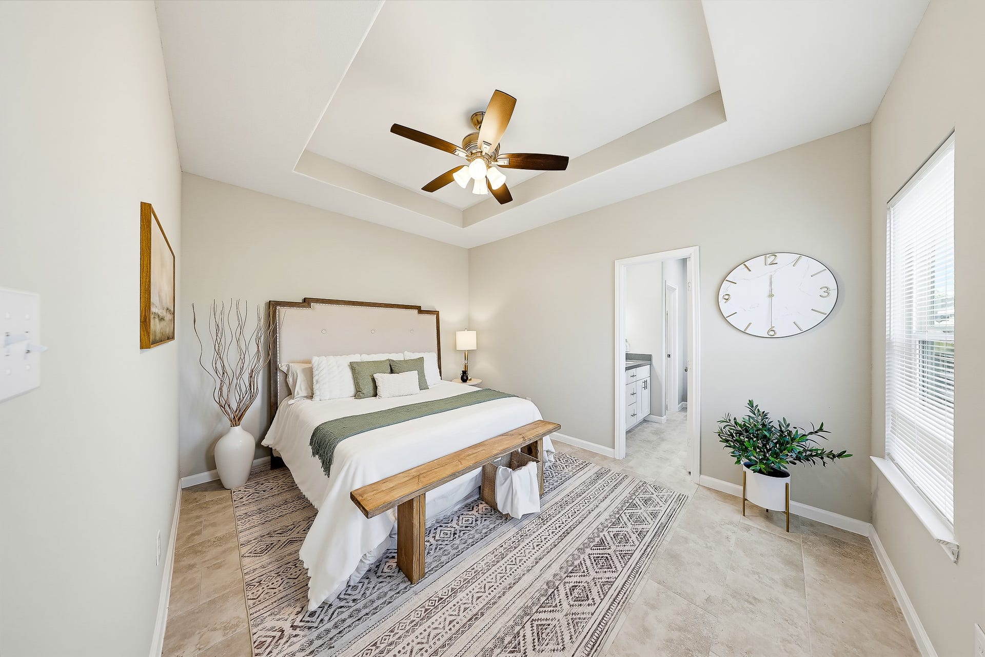 313 De Haven Street, Houston, TX 77029 Retreat downstairs to a primary bedroom with soft natural light and a distinctive tray ceiling.