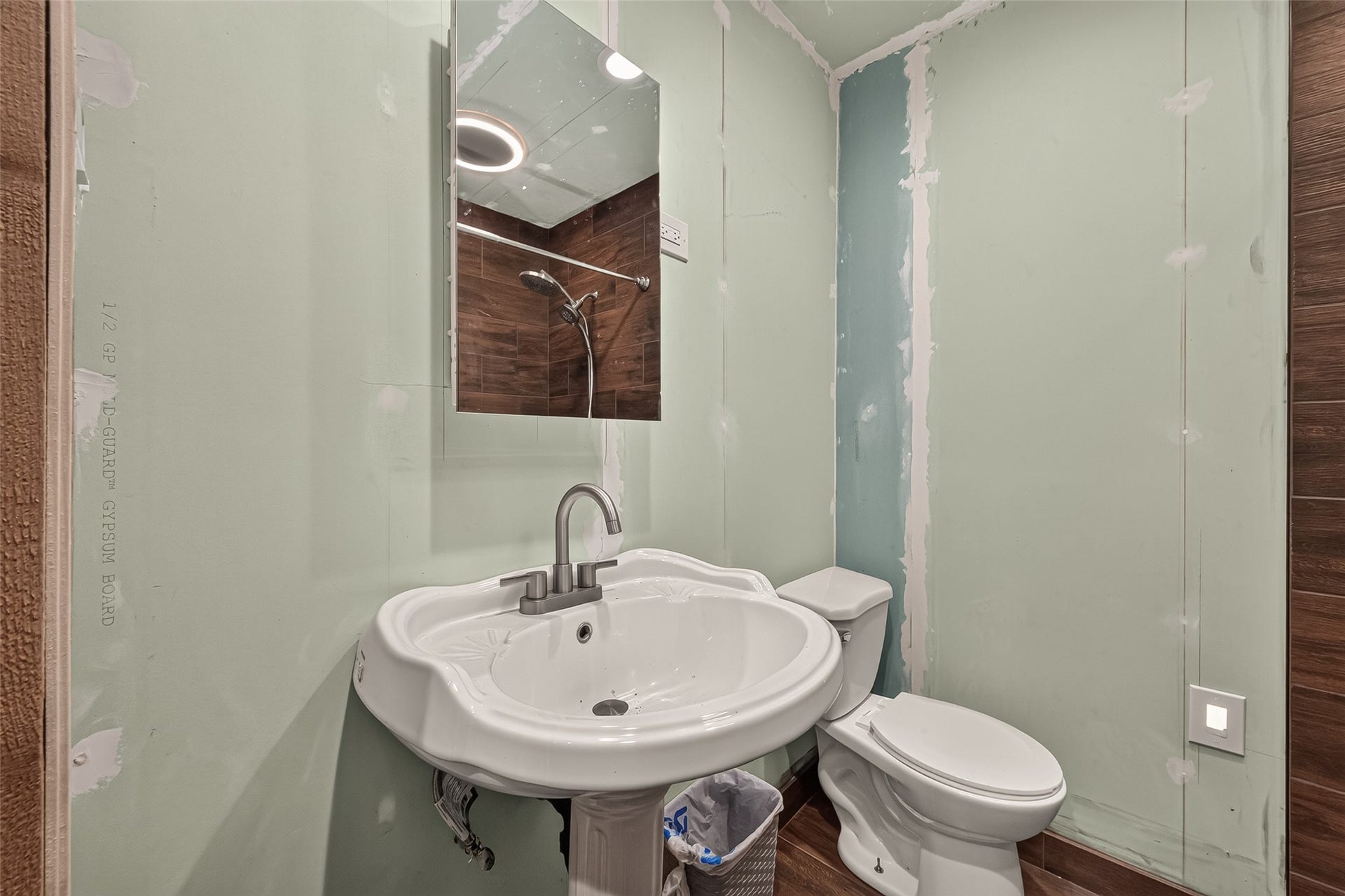 18614 Mink Lake Drive, Magnolia, TX 77355 Half bathroom with a pedestal sink.