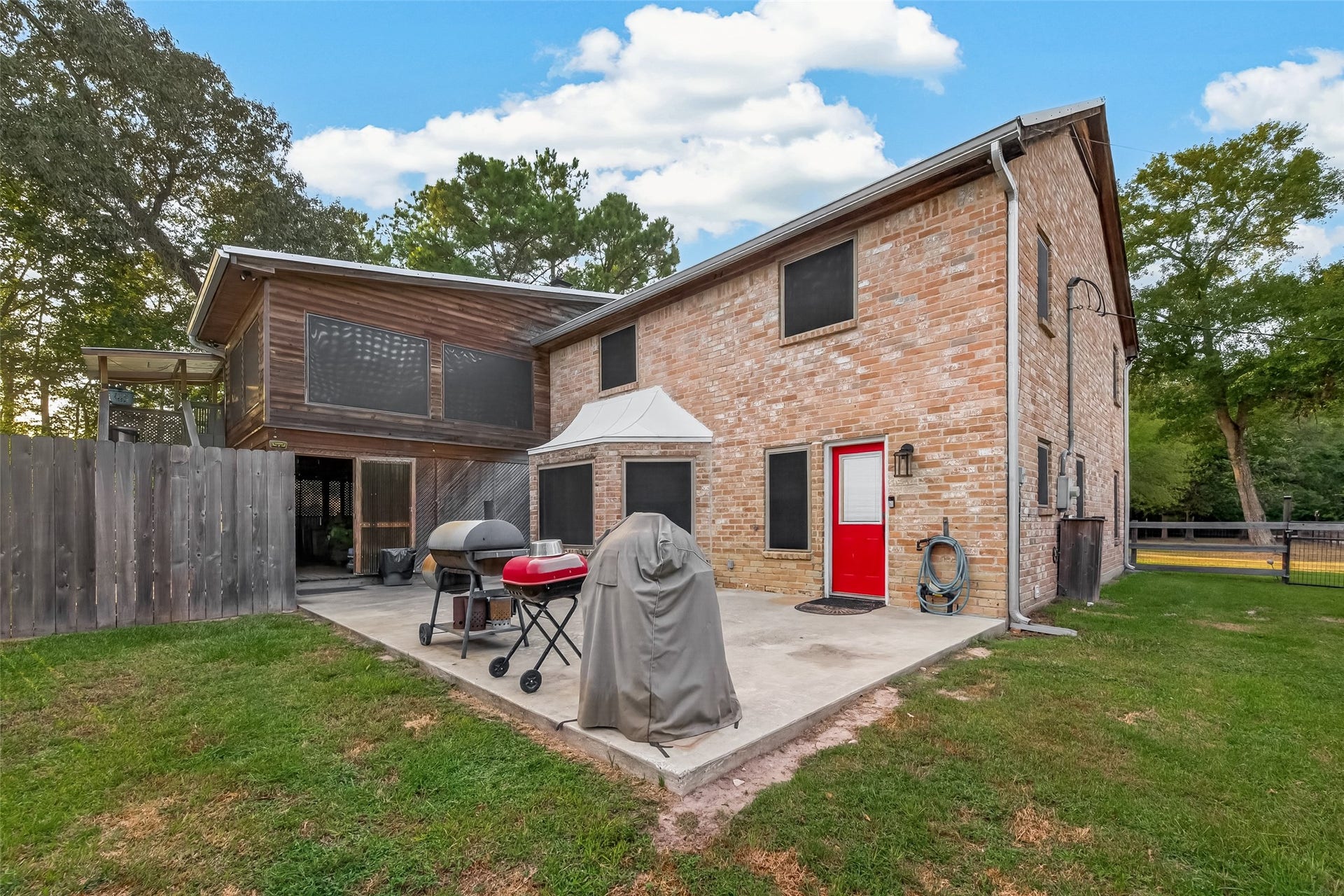 18614 Mink Lake Drive, Magnolia, TX 77355 Rear exterior view showcasing the two-story home and backyard space.