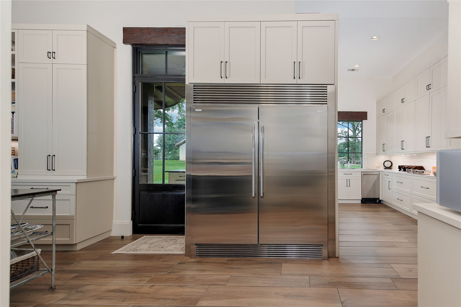 The caterers kitchen includes an Electrolux double wide refrigerator, plenty of shelving for serving dishes and open shelving for pantry staples. The prep kitchen also offers a second dishwasher, sink, microwave, along with cabinet and drawer storage for all your kitchen equipment. A private half bath is perfect for visiting caterers.
