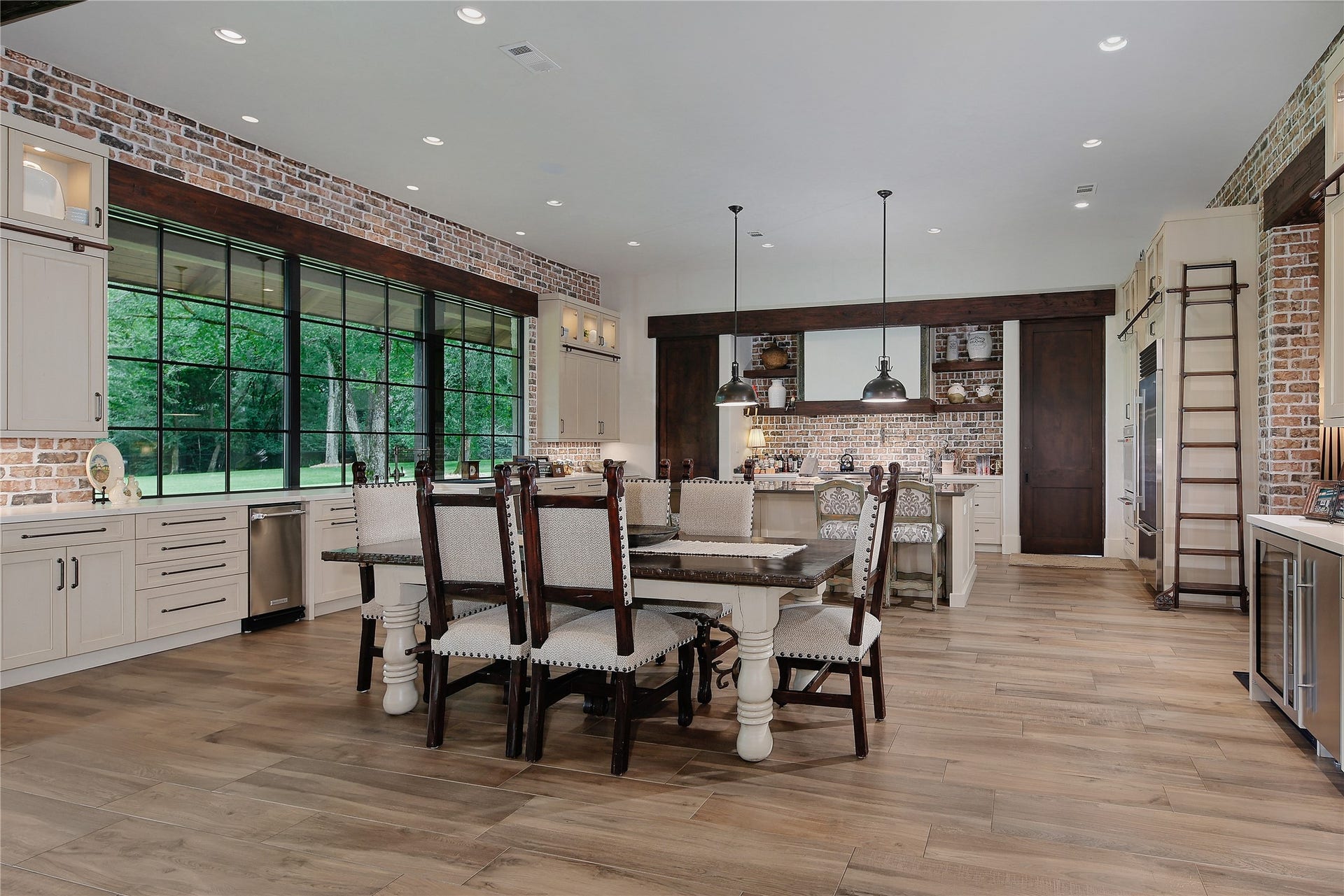 More casual dining in this open concept breakfast room and kitchen with additional seating at the bar.