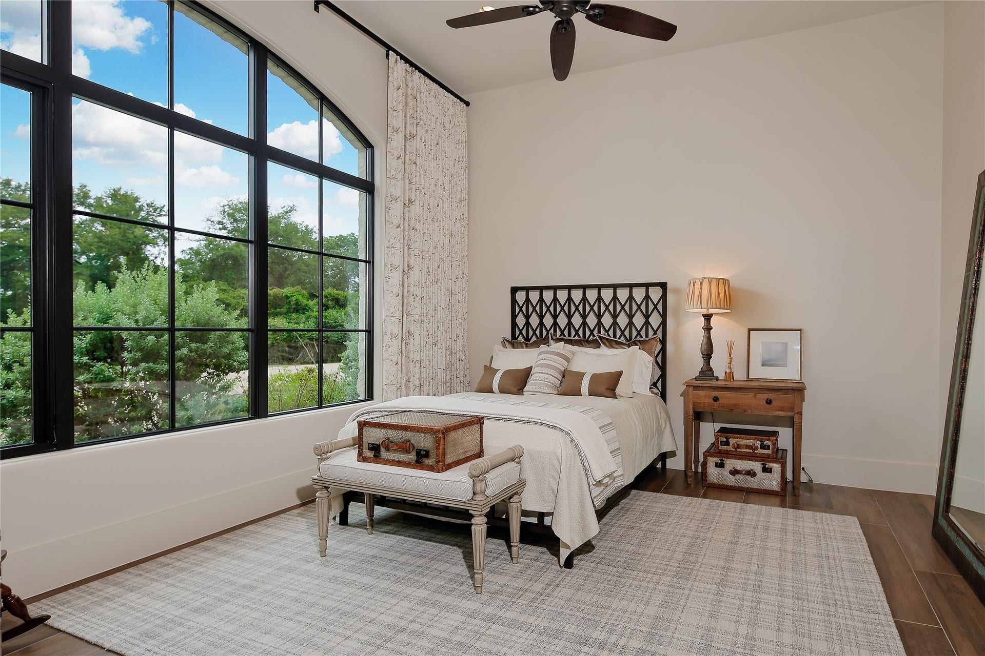 A downstairs guest suite with private bath and shower. Custom draperies and views of the front of the property.