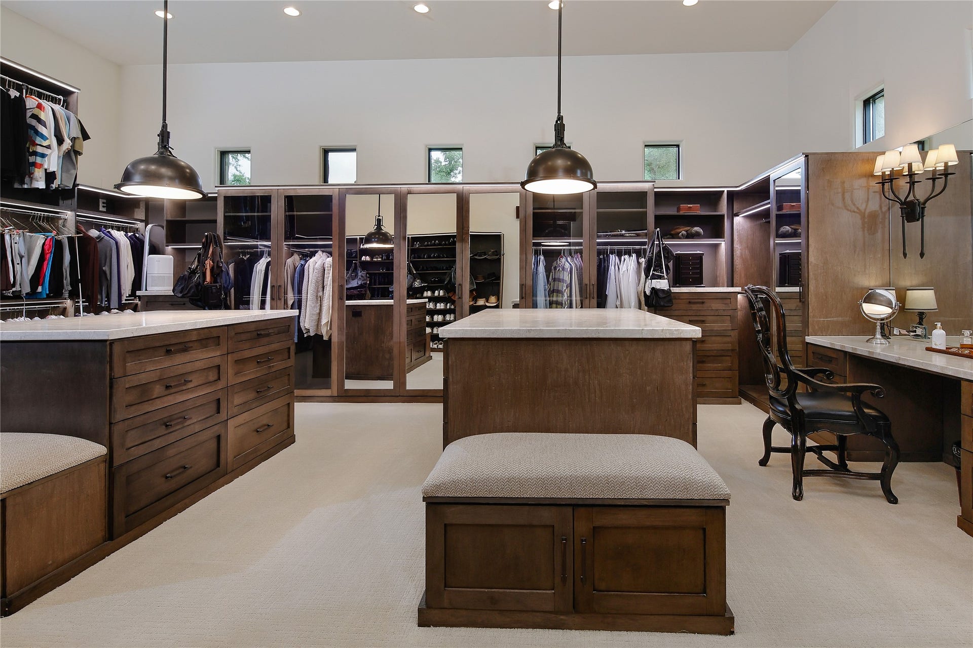 Two enormous walk in closets both equally as generous in space and features. An elegant vanity area, two huge islands with quartzite countertops, mirrored closets, shoe shelving and tons of drawer space.