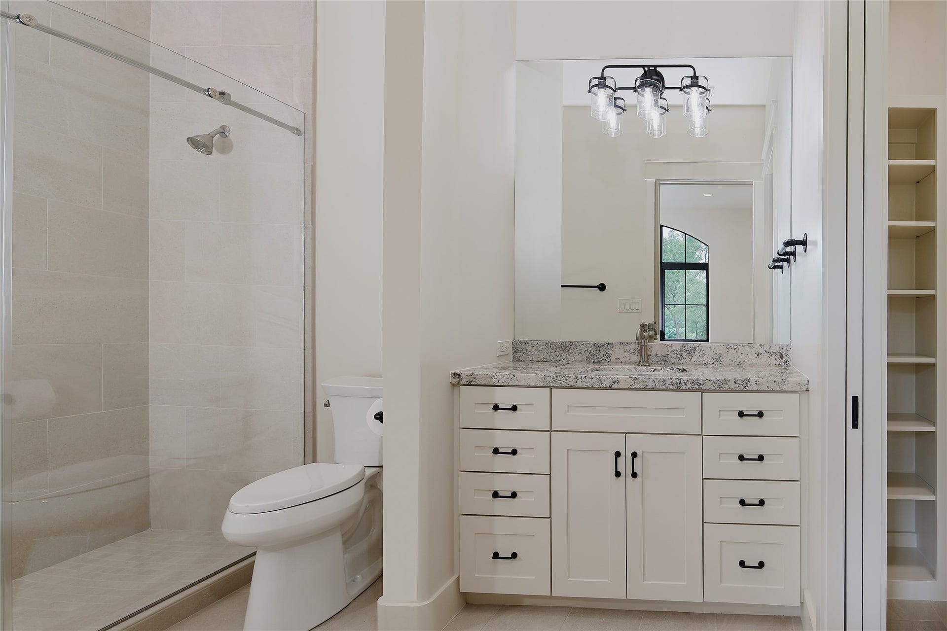 One of the two full bathrooms upstairs with large showers and stone vanities.