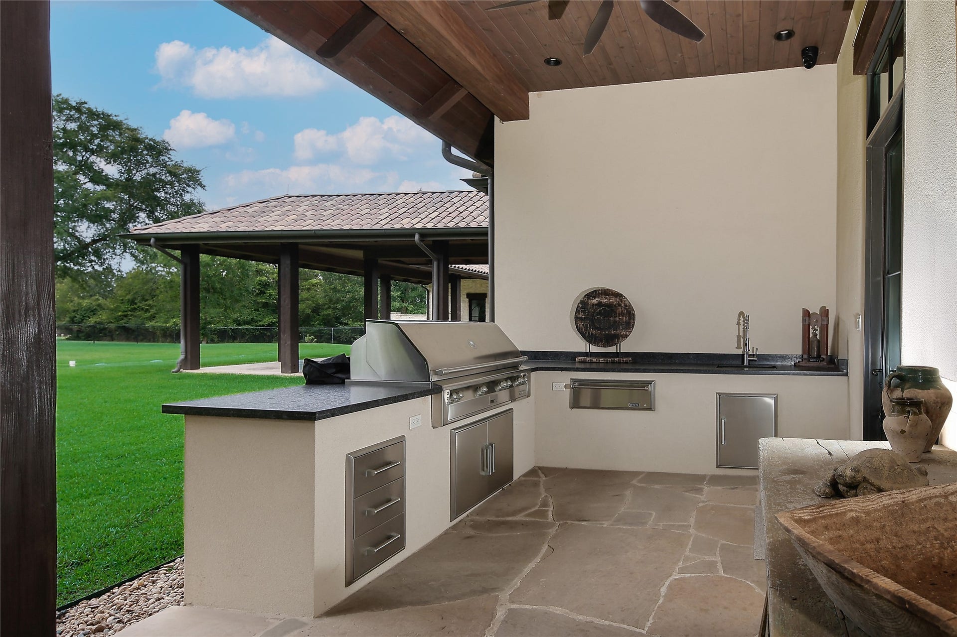 For the bar-b-que enthusiast this outdoor kitchen is complete with grill, warming drawer, sink, storage and plenty of countertop space.