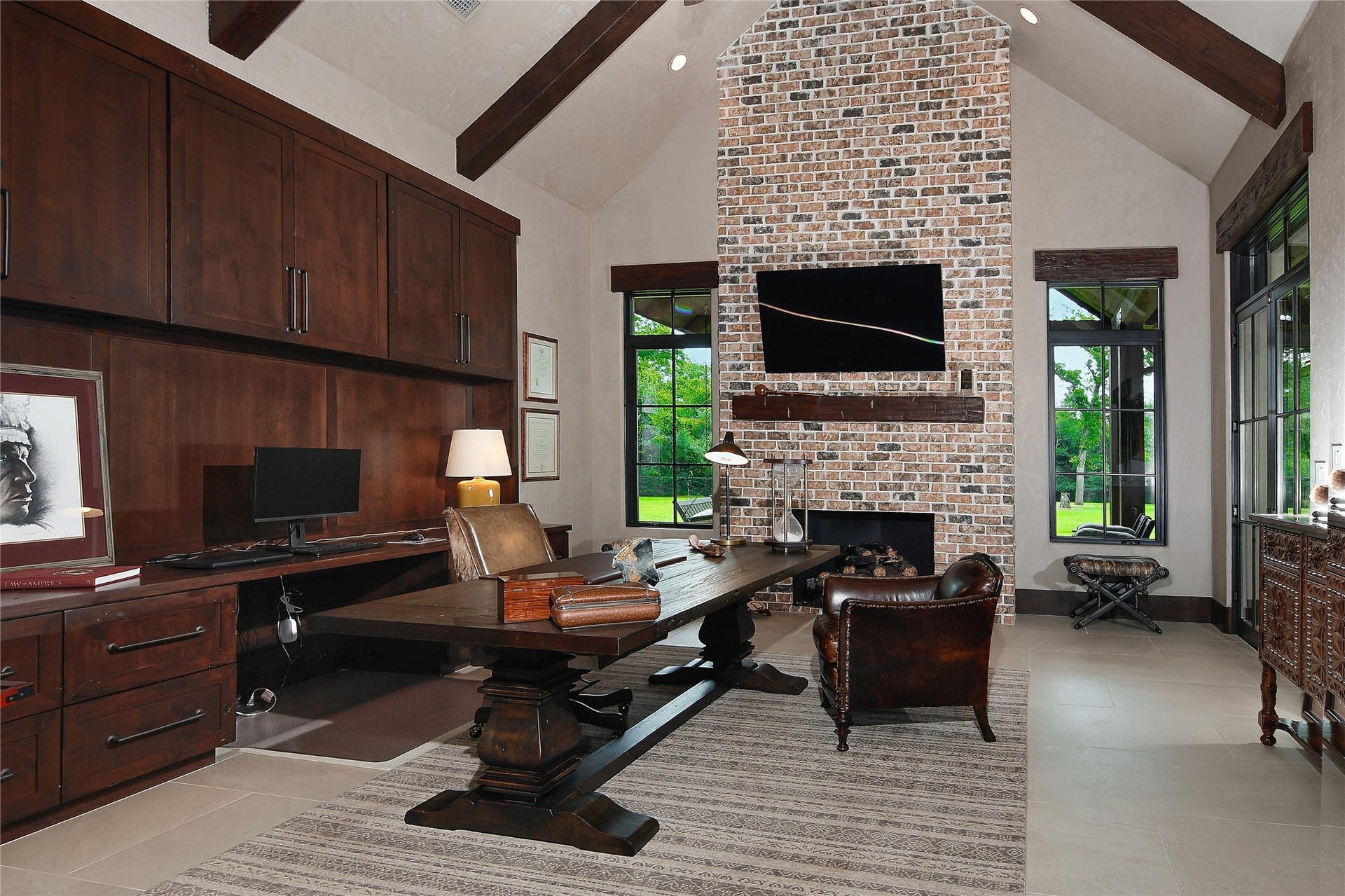 This is one of two studys or home offices. This one has French doors that take you into the library and the back terrace patio. A private half bath, beautiful Custom built cabinetery and gas log fireplace make this the ideal workplace.