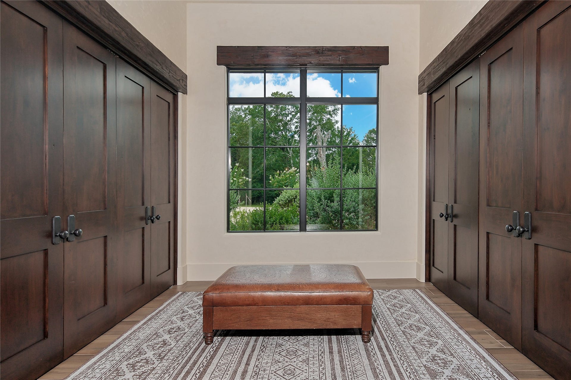 Perfect for large parties these bi-fold custom doors open to closet space to accomodate guests coats. This area is located next to a luxurious powder bath for guests off the entry.