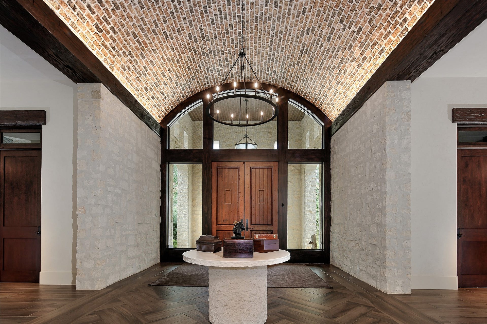 This dramatic foyer with Custom lighting welcomes your guests.
