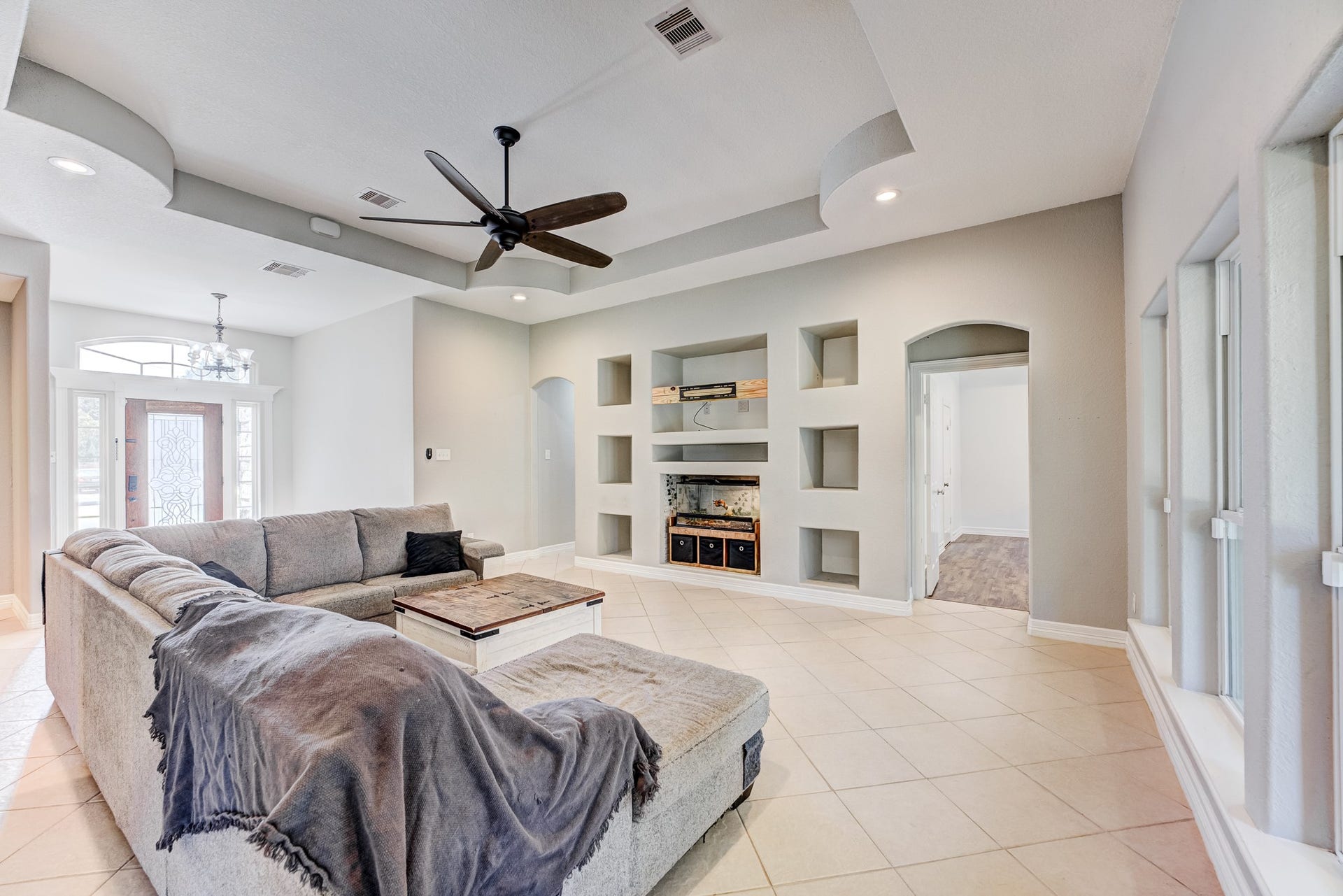 Open living area with custom niches, modern finishes, and seamless flow.