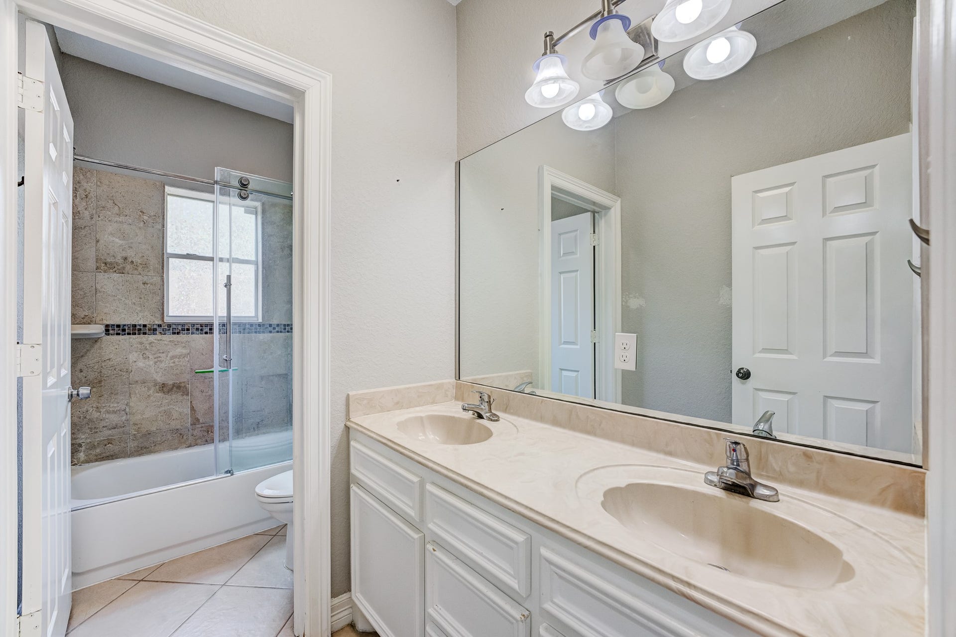 Additional full bathroom featuring an oversized vanity and ample counter space.
