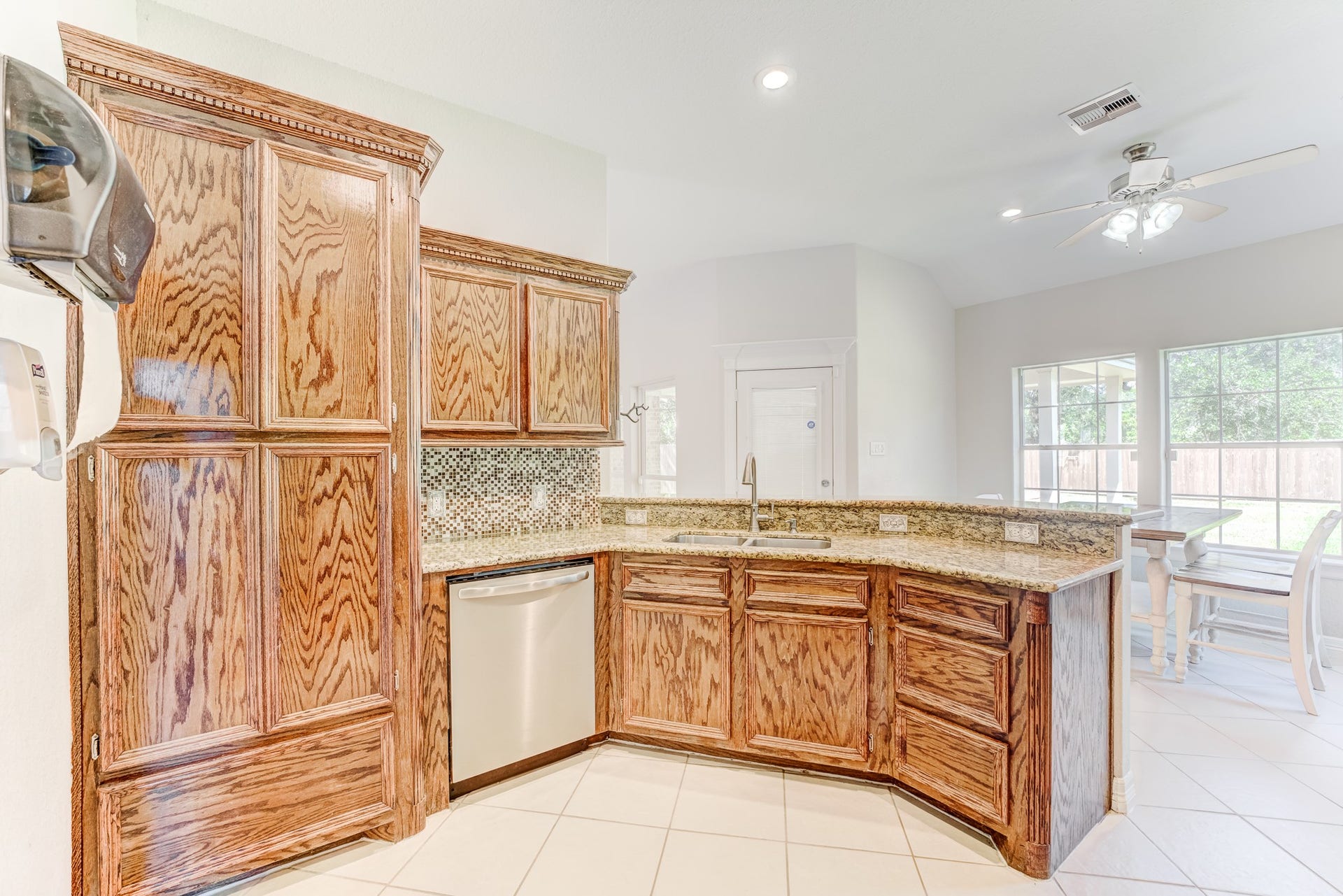 Large kitchen with wraparound counters and abundant custom wood cabinetry.