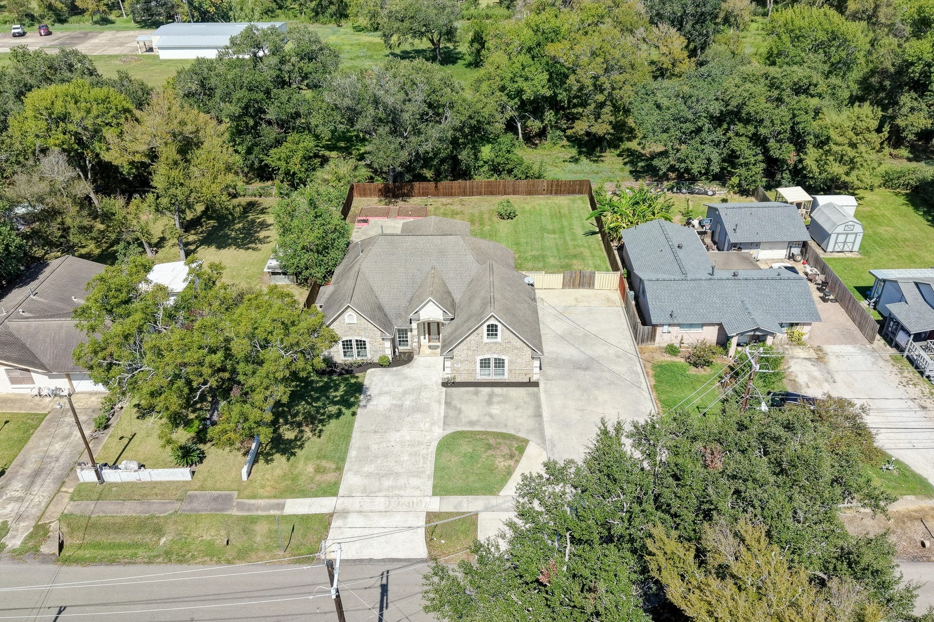 Aerial view highlighting the home's footprint, lot size, and surrounding landscape.