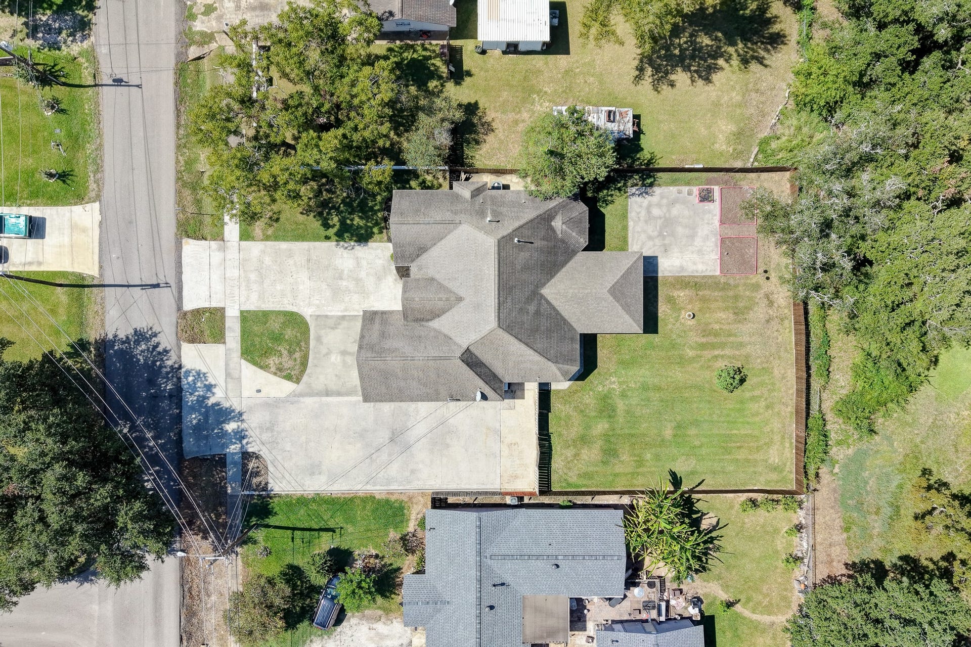 Aerial view highlighting the home's placement on the lot with no homes directly behind it.