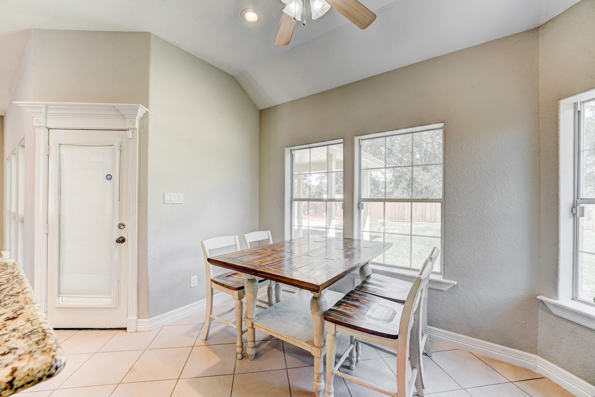 Spacious dining nook with large windows providing abundant natural light.