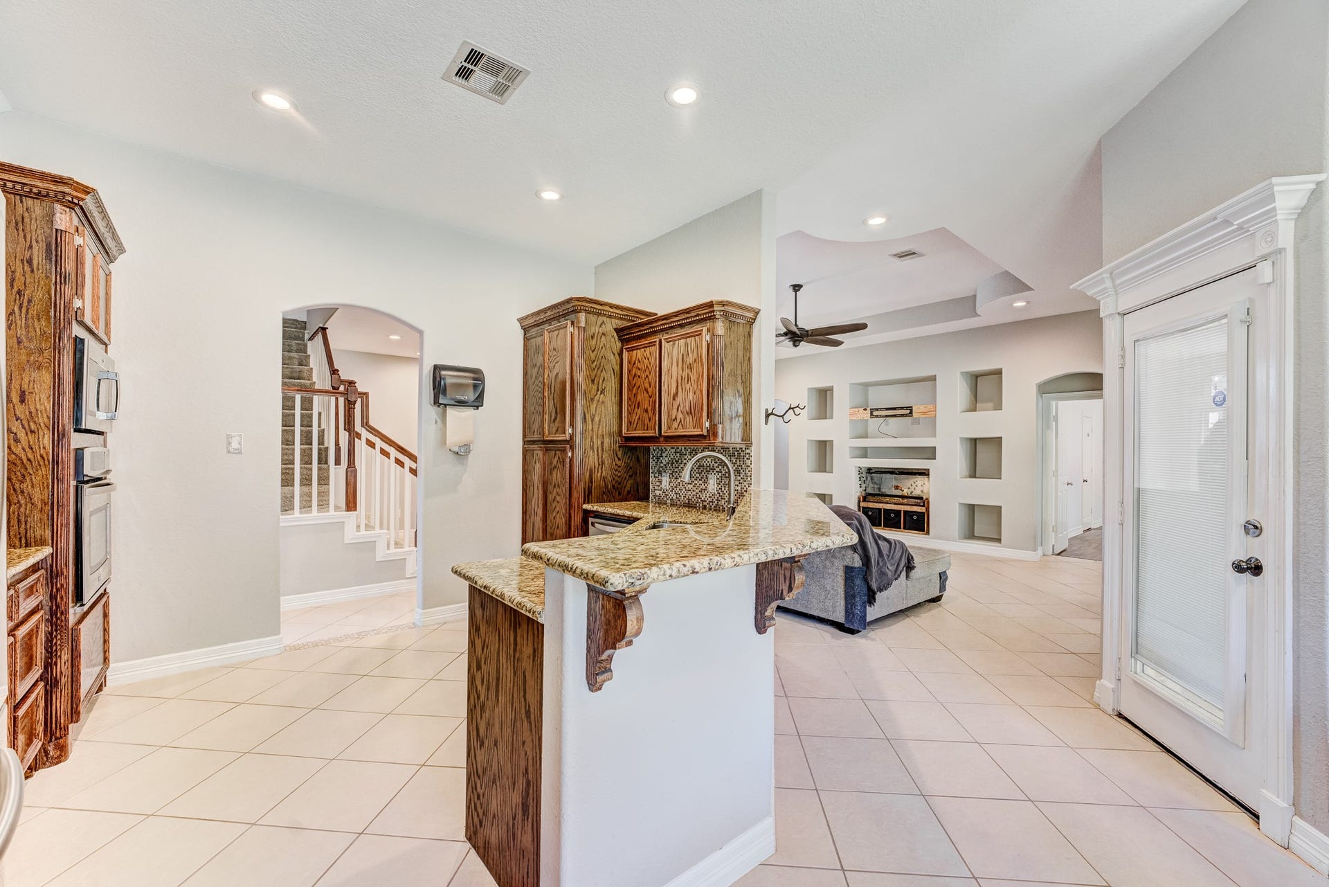 Functional kitchen layout with breakfast bar and easy access to living areas.