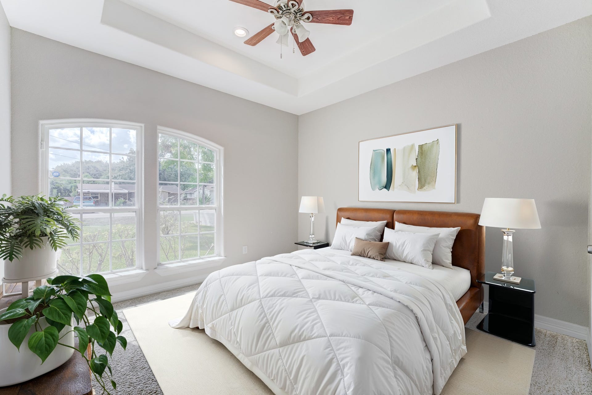 **Virtually Staged** Bright secondary bedroom with large windows and tray ceiling detail.
