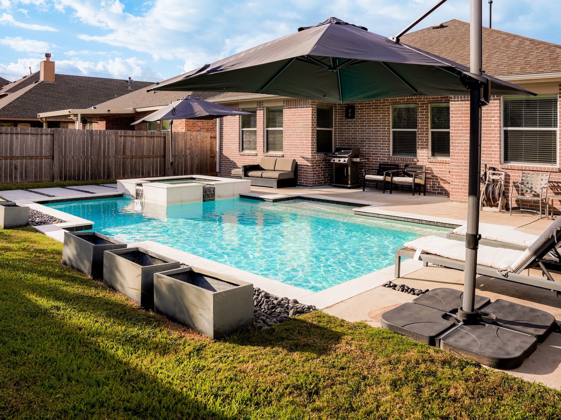 24531 Via Salerno Court, Richmond, TX 77406 Resort style pool with raised spa tub.