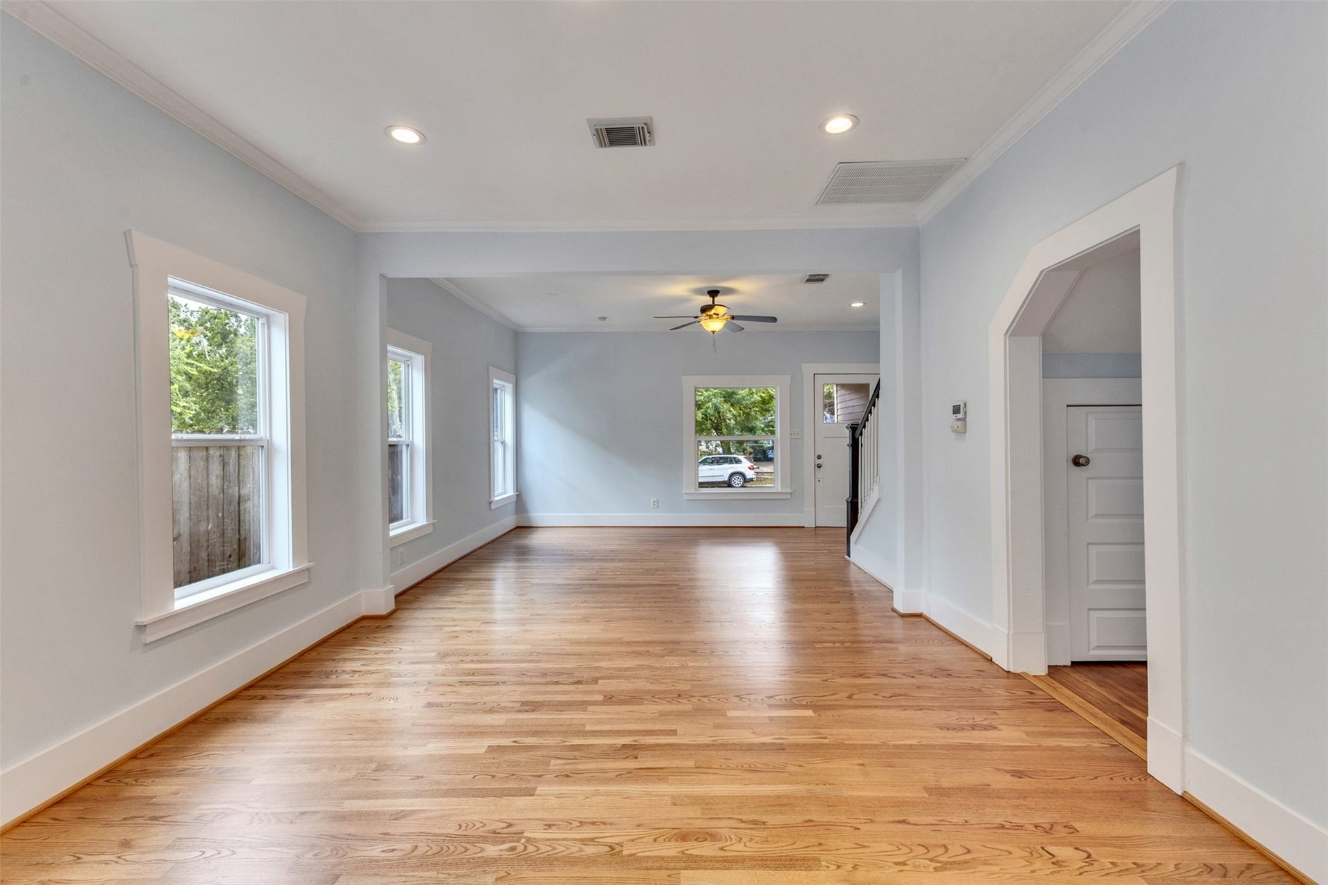 4534 Woodside Street, Houston, TX 77023 Spacious and bright living area with beautiful hardwood floors, ample natural light from multiple windows, and elegant crown molding. Perfect for entertaining or relaxing.