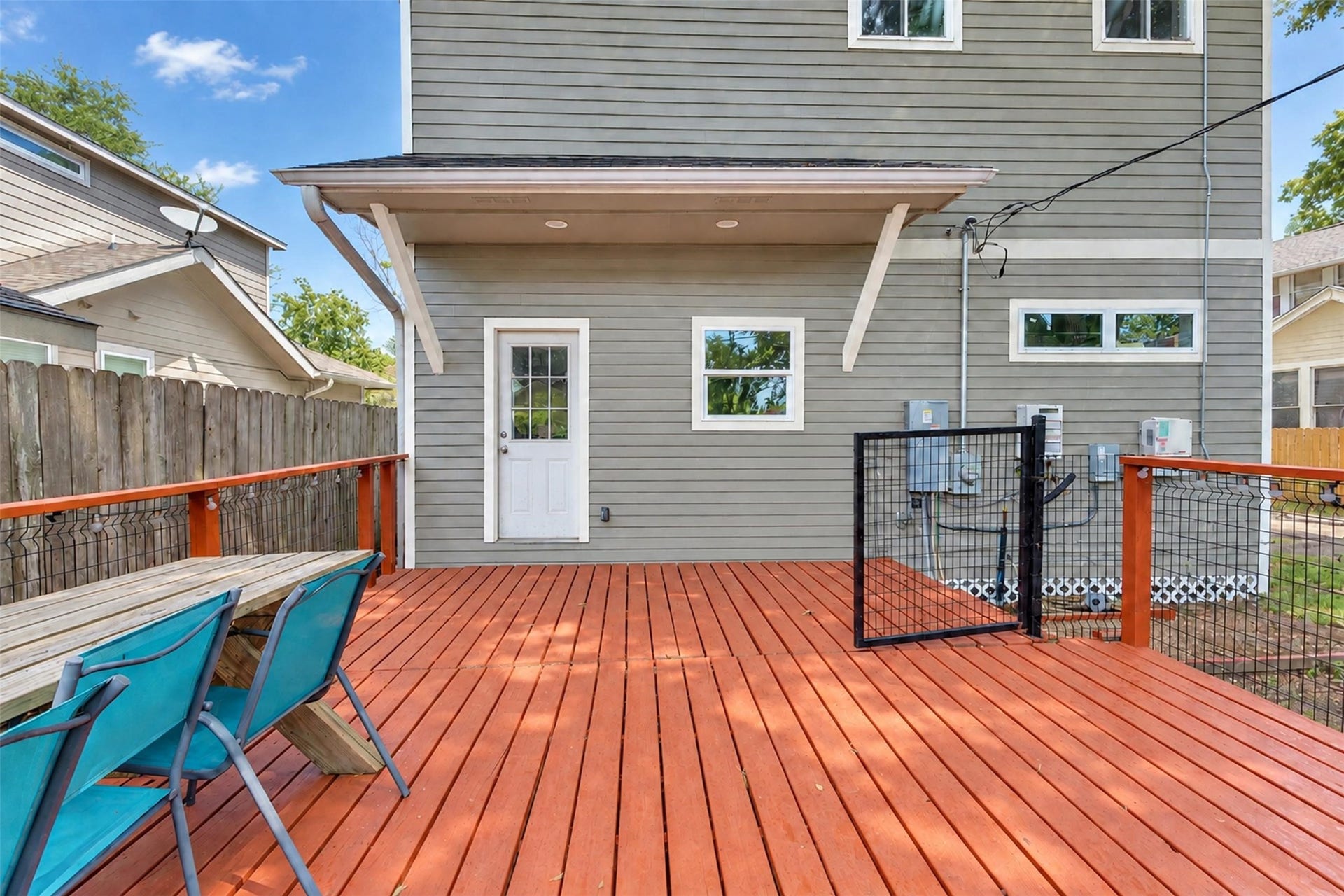 4534 Woodside Street, Houston, TX 77023 Spacious backyard deck with modern railing and ample seating, perfect for outdoor gatherings and relaxation.