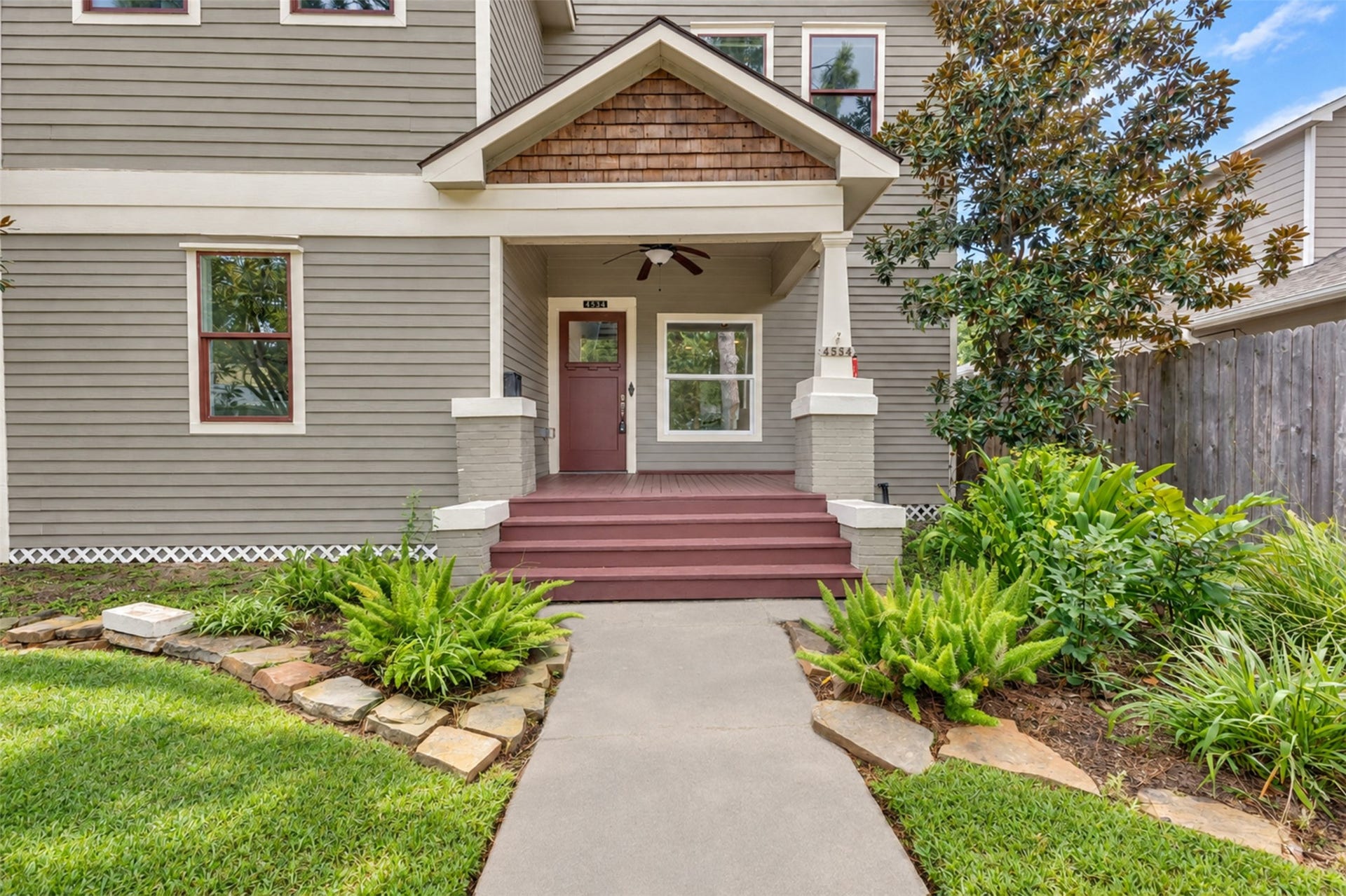 4534 Woodside Street, Houston, TX 77023 Charming home with classic appeal features a welcoming front porch, lush landscaping, and a well-maintained exterior.