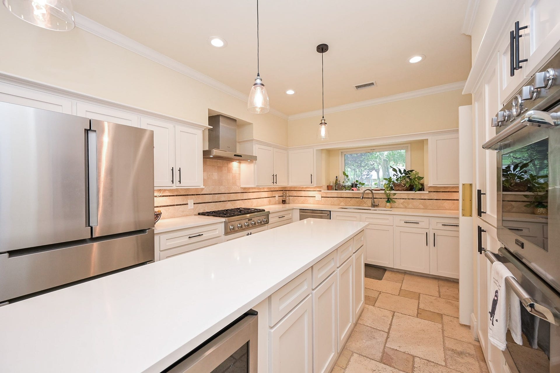 Enjoy washing dishes more while looking through the picture window to the lush landscaping outdoors