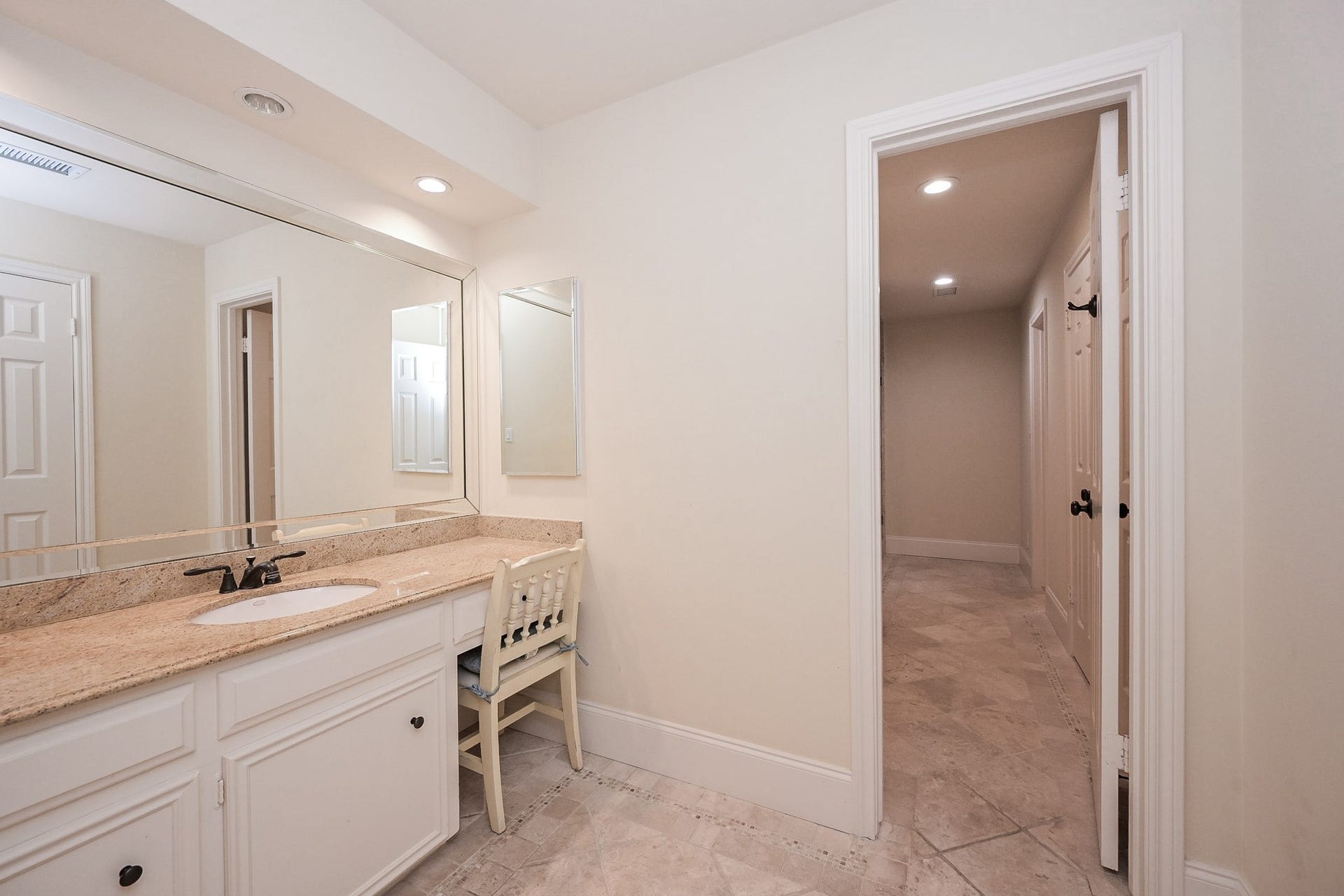 Private vanity area and closet in hollywood bath