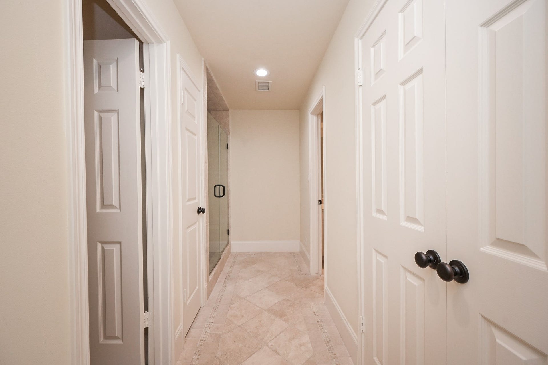 Hollywood bath has a toilet closet on the left, large linen closet on the right and smaller one on the left as well as a walk-in shower.