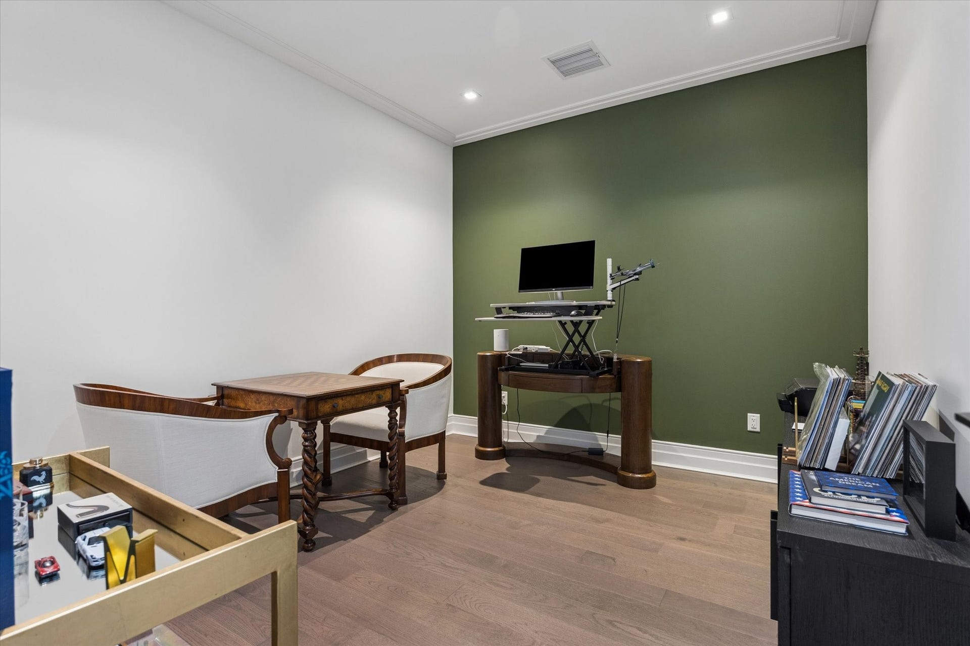 6017 Memorial Drive, #505, Houston, TX 77007 Offering versatility to suit a variety of lifestyles, the third bedroom is currently arranged as a private home office and sitting area. Engineered hardwood flooring, recessed lighting, and a distinctive accent wall create a comfortable, contemporary environment. Whether used as a dedicated workspace, guest bedroom, or personal retreat, this flexible space complements the residence's thoughtful layout and sophisticated lock-and-leave lifestyle.