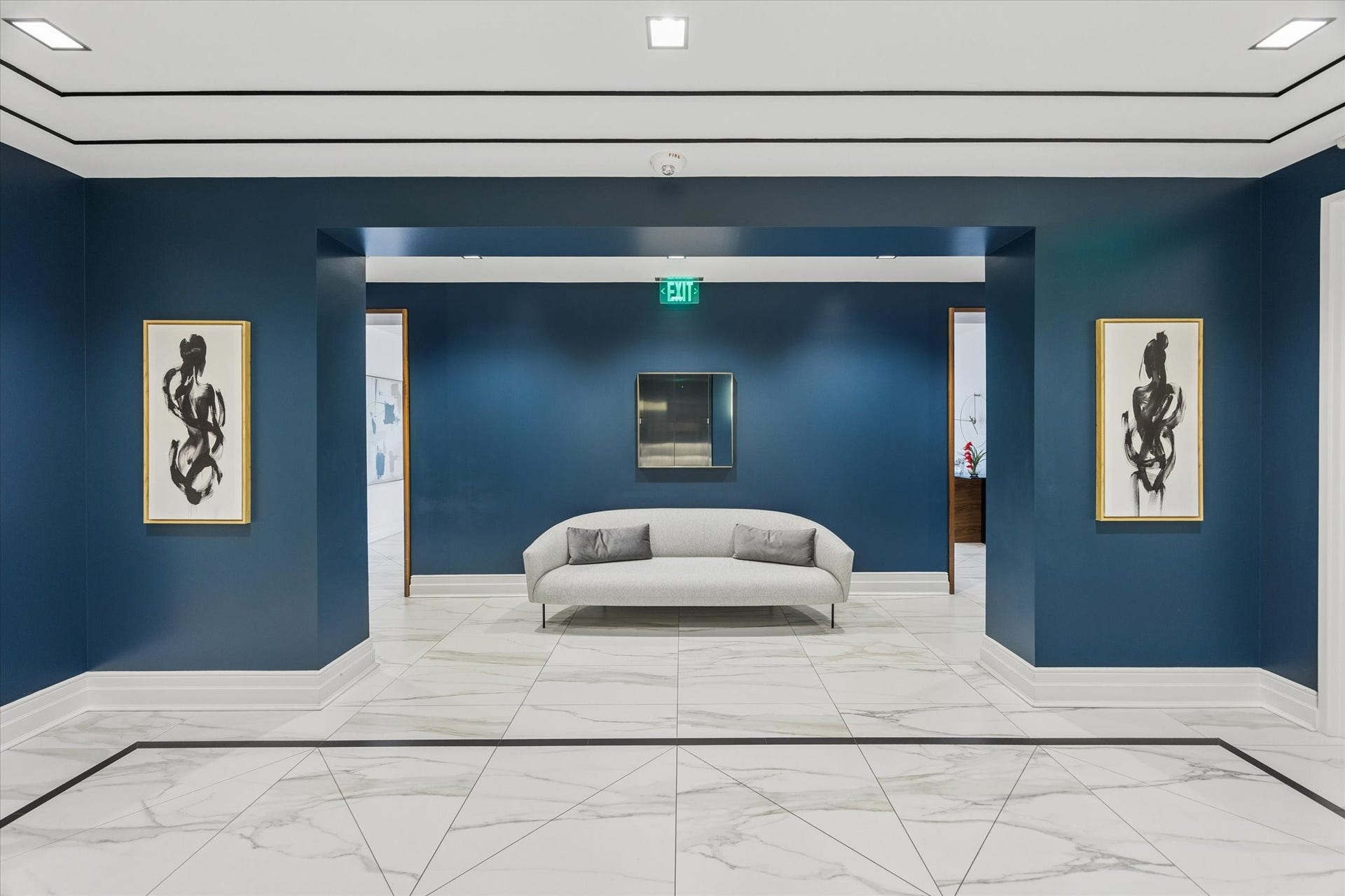 6017 Memorial Drive, #505, Houston, TX 77007 Sophisticated architectural detailing distinguishes The Sophie's elegant interior lobby. Rich navy walls contrast beautifully with polished stone flooring, crisp white millwork, and carefully curated artwork. The symmetrical design and refined furnishings create a striking yet welcoming atmosphere, reflecting the building's commitment to timeless luxury. Every detail contributes to the intimate, exclusive residential experience that defines life at The Sophie.