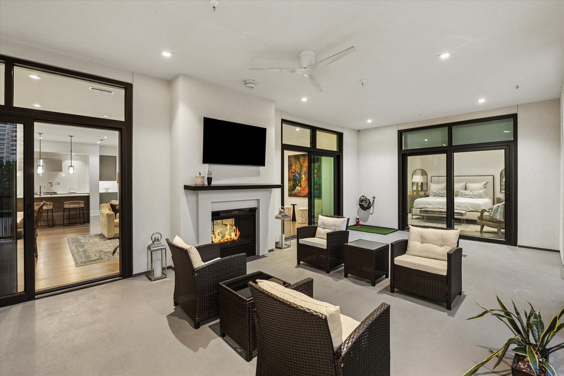 6017 Memorial Drive, #505, Houston, TX 77007 An exceptional extension of the residence, this expansive private terrace offers a sophisticated setting for outdoor living and entertaining. A striking fireplace, ceiling fan, and generous seating areas create an inviting atmosphere year-round. Floor-to-ceiling glass doors connect the terrace to the living spaces and primary suite, blending indoor comfort with the elegance of open-air living.