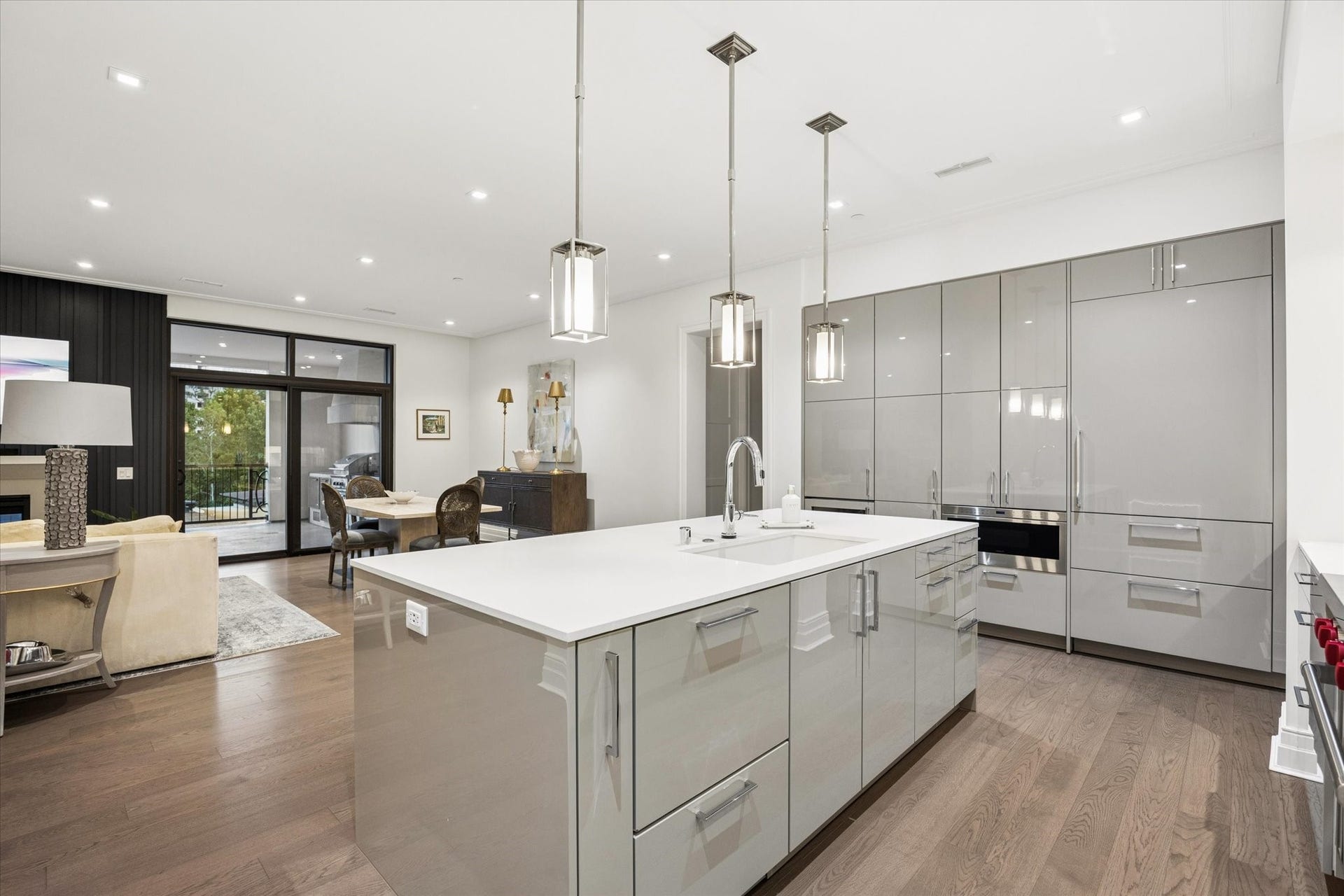 6017 Memorial Drive, #505, Houston, TX 77007 This stunning European-inspired kitchen blends sophisticated design with exceptional functionality. An expansive quartz island, sleek SieMatic cabinetry, and elegant pendant lighting create a refined culinary setting. Premium integrated appliances preserve the kitchen's clean architectural lines, while the open layout provides an uninterrupted visual connection to the living and dining areas and private terrace beyond.