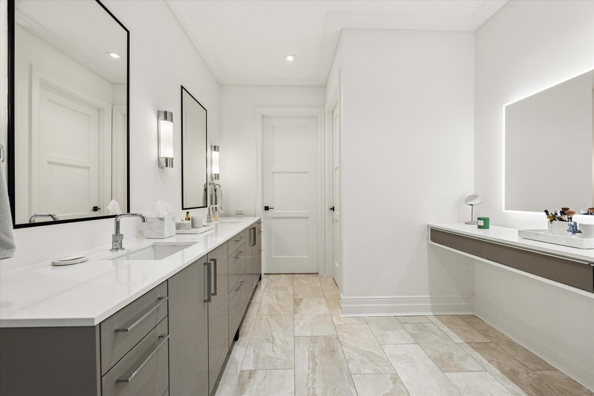 6017 Memorial Drive, #505, Houston, TX 77007 The expansive primary bathroom combines sophisticated contemporary design with exceptional everyday functionality. Beautiful porcelain tile flooring, sleek SieMatic cabinetry, and elegant quartz countertops establish a refined aesthetic. A spacious dual-sink vanity offers generous storage, while a separate illuminated vanity area provides a dedicated space for personal grooming. Clean architectural lines and thoughtfully selected finishes create a serene, spa-like atmosphere.