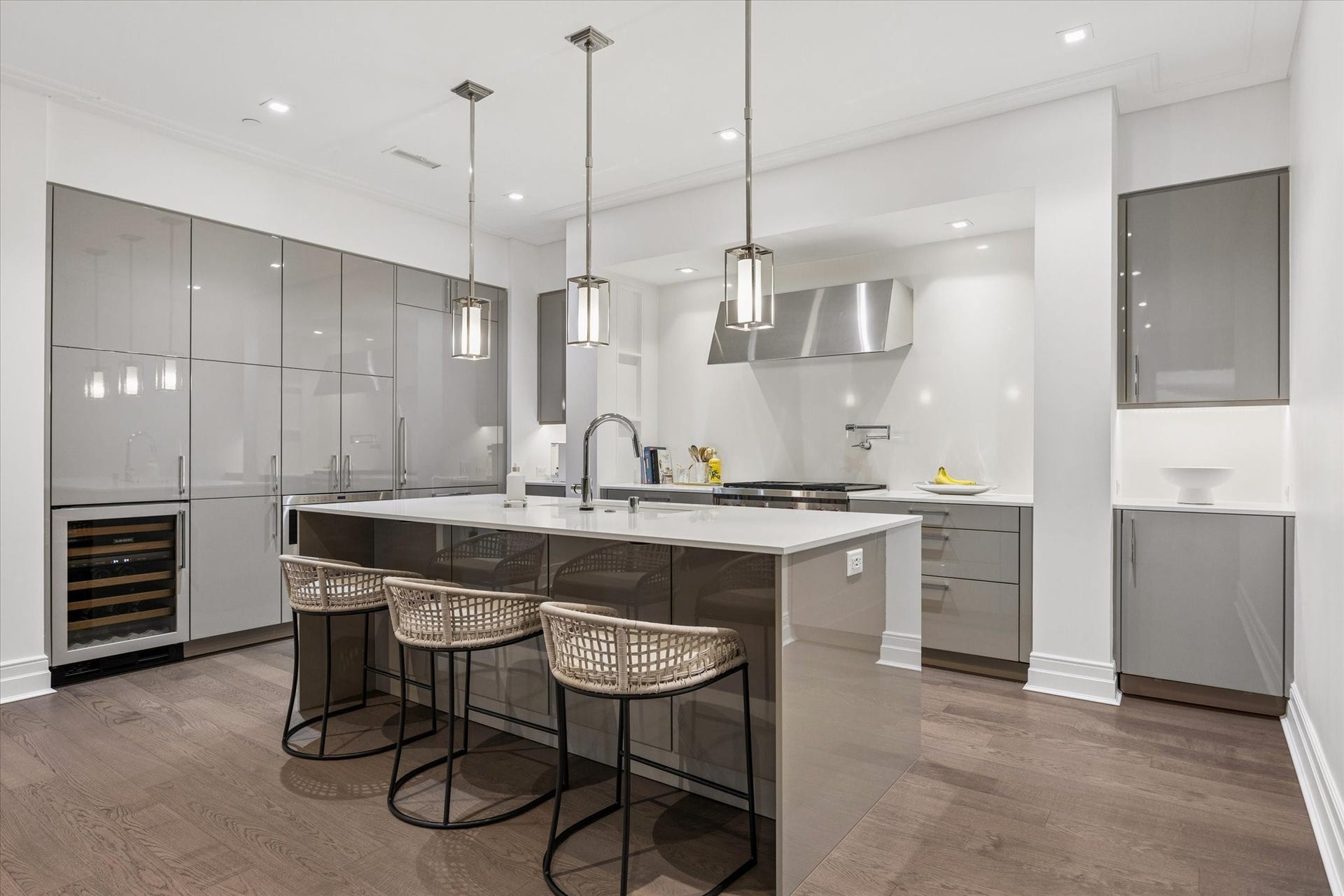 6017 Memorial Drive, #505, Houston, TX 77007 A showcase of contemporary European design, this beautifully appointed kitchen features sleek SieMatic frameless cabinetry, elegant quartz countertops, and a spacious island with breakfast seating. Premium Sub-Zero and Wolf appliances, a striking stainless steel range hood, and a built-in beverage center complement the sophisticated design. Contemporary pendant lighting, under-cabinet illumination, and rich hardwood flooring complete this exceptional culinary space.