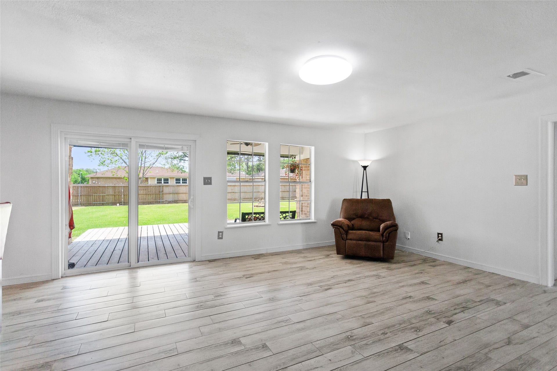 5001 Texas Avenue, La Marque, TX 77568 Family room has lots of natural lighting and a serene view of the patio and huge backyard.