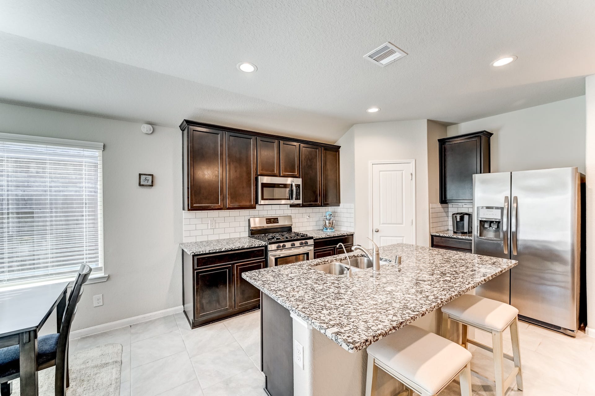 18306 Arcola Bay Lane, Richmond, TX 77407 Island kitchen with breakfast bar