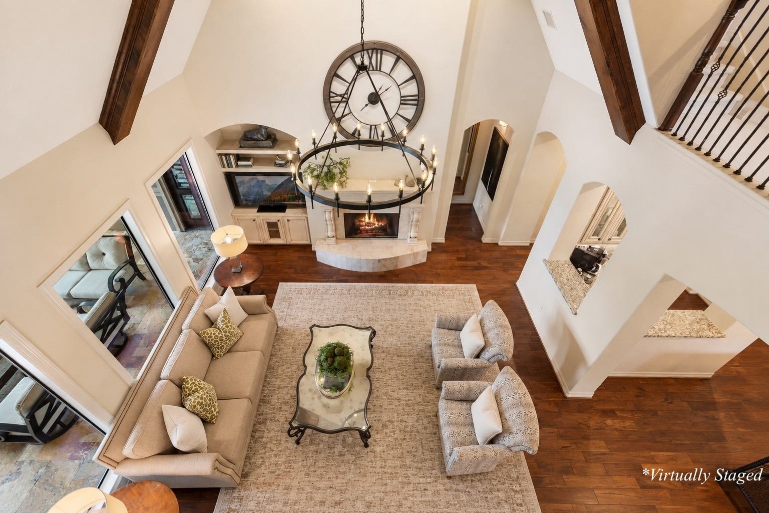 Open second-floor overlook providing a dramatic perspective of the homes soaring ceilings and beautifully designed living spaces below. *Virtually Staged decor accents