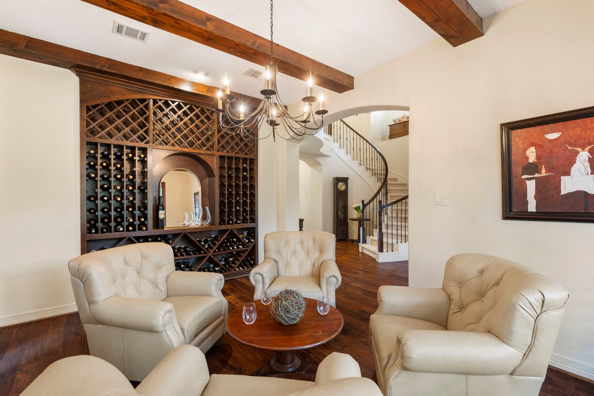 The wall of custom built-ins create the perfect setting for dining, entertaining, or showcasing a curated wine collection.