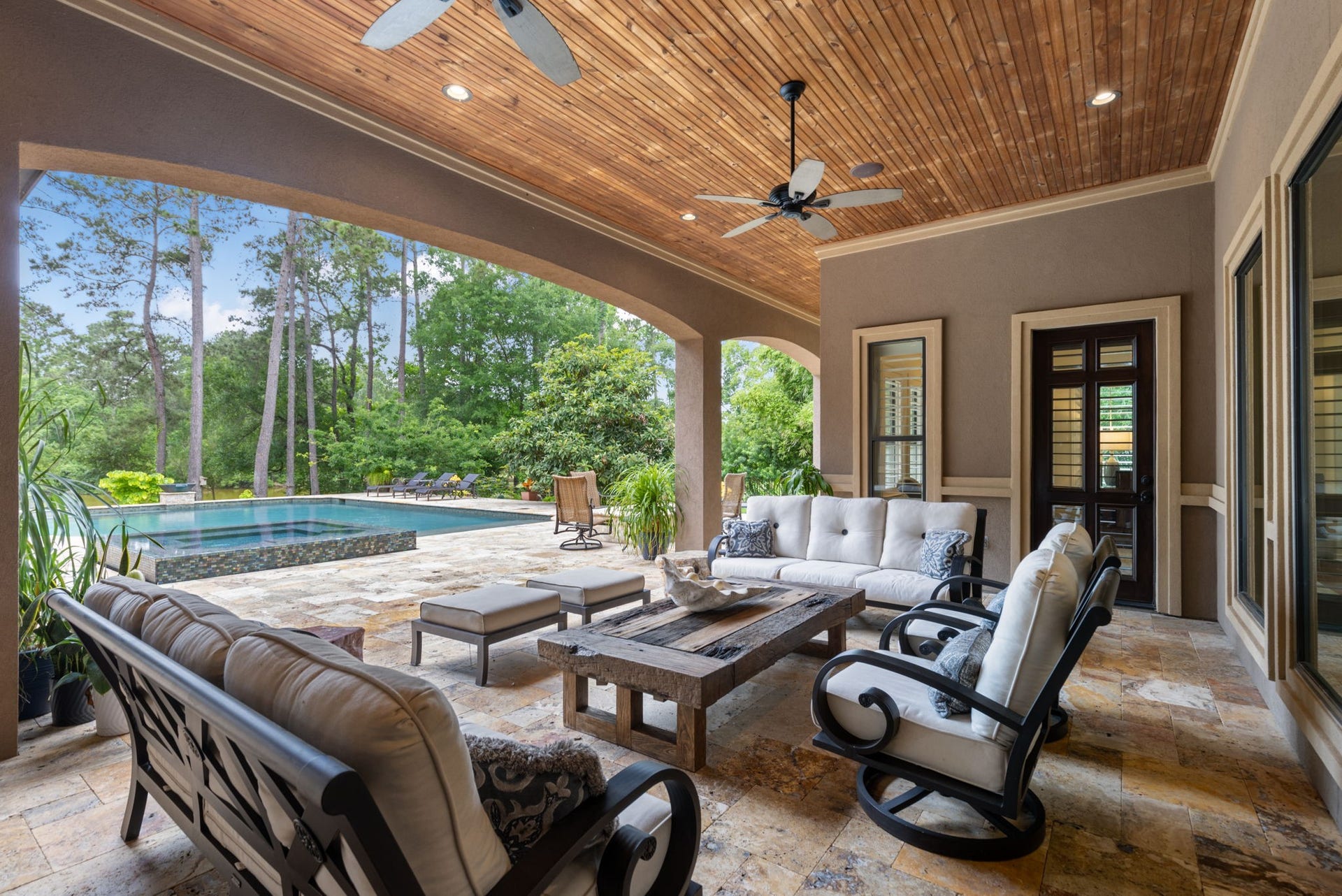 Expansive covered patio just off the Breakfast Room and Game & Trophy Lounge with a wood-paneled ceiling, ceiling fans, and integrated sound systemperfect for indoor/outdoor entertaining.
