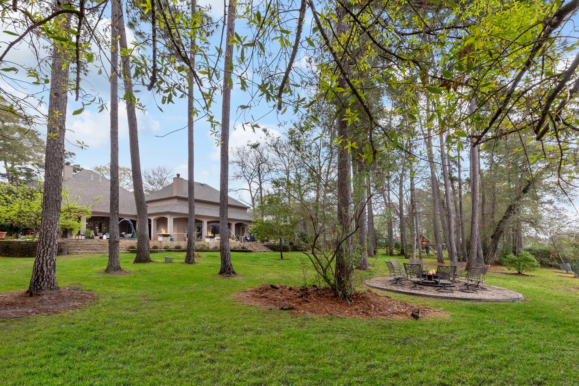 Expansive greenspace offers plenty of room for a playset, trampoline, or simply enjoying the open yard.