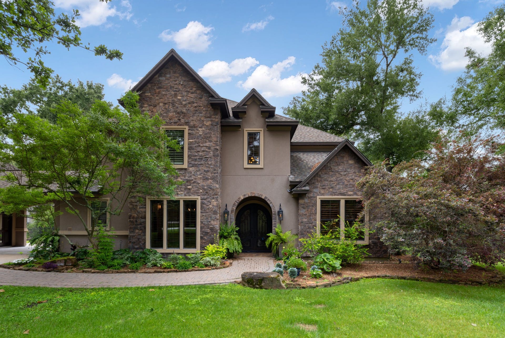 Custom stone and stucco estate tucked behind a private gated entrance on one of the most sought-after streets in Benders Landing.