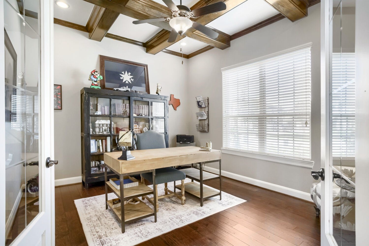 The sun drenched office is designed to inspire, showcasing soaring ceilings accented with striking exposed beams and a abundance of natural light that creates an airy, sophisticated workspace