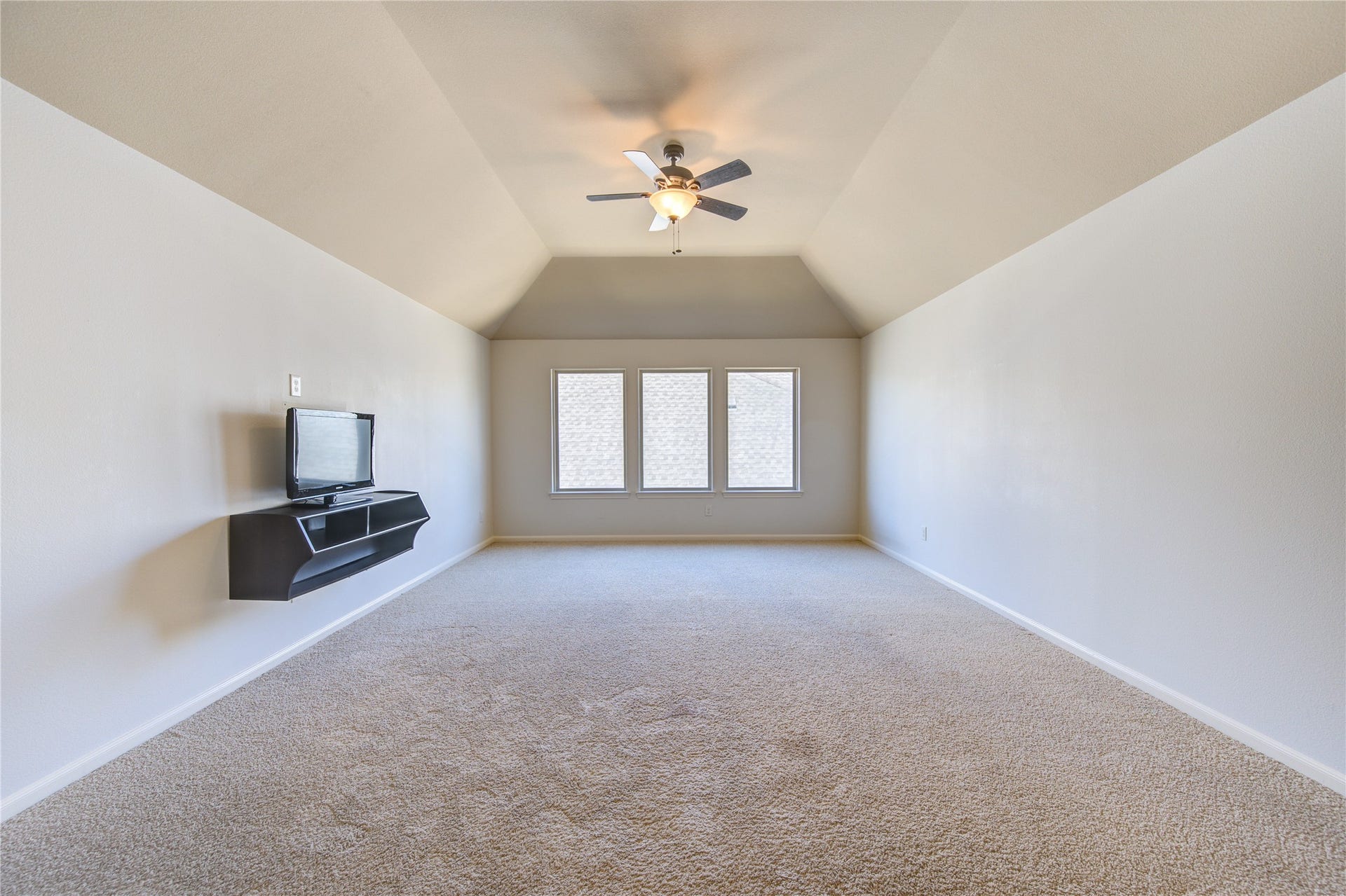 Game room with ceiling fan and great natural light.