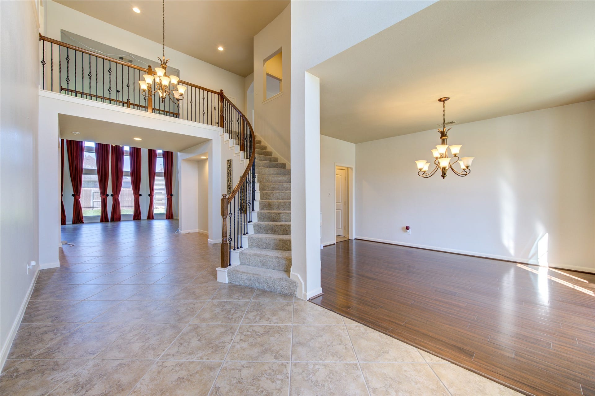 Ample dining room space with wood flooring and chandelier