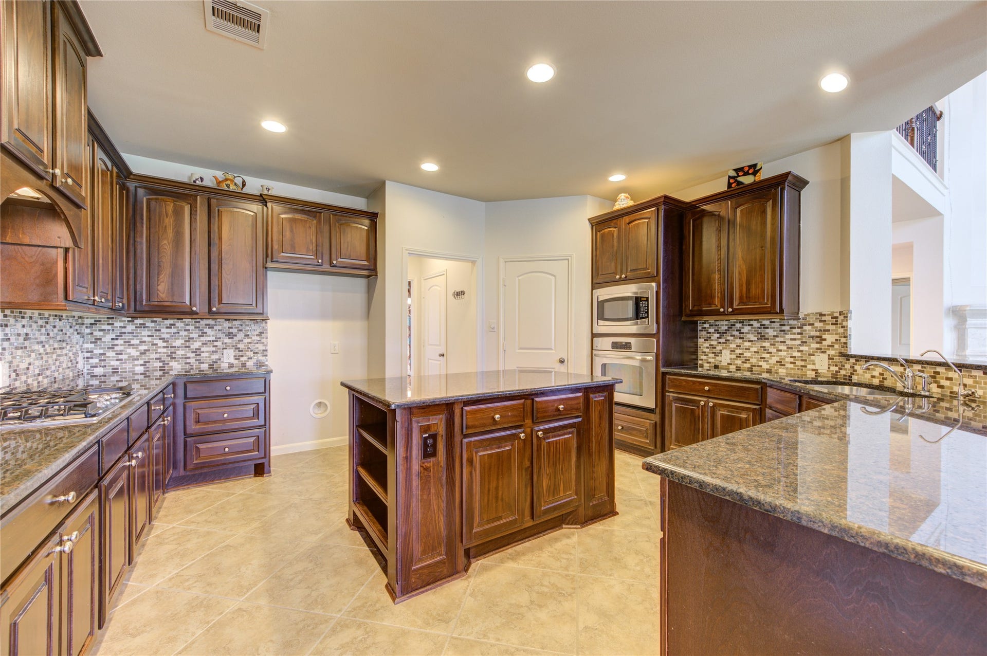 Rich wood finish cabinets, large island,