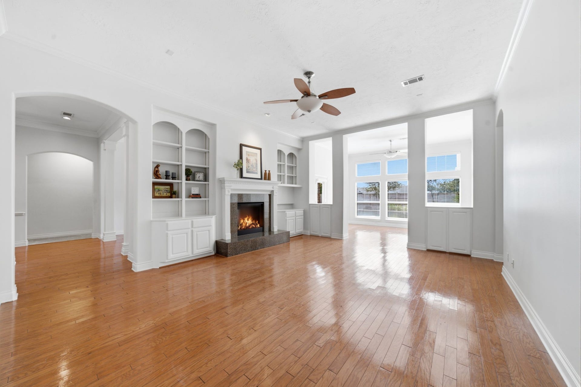 1227 Wellshire Drive, Katy, TX 77494 The famiily room opens to the kitchen and sunroom with high ceilings, built in storage and remote controlled fireplace.