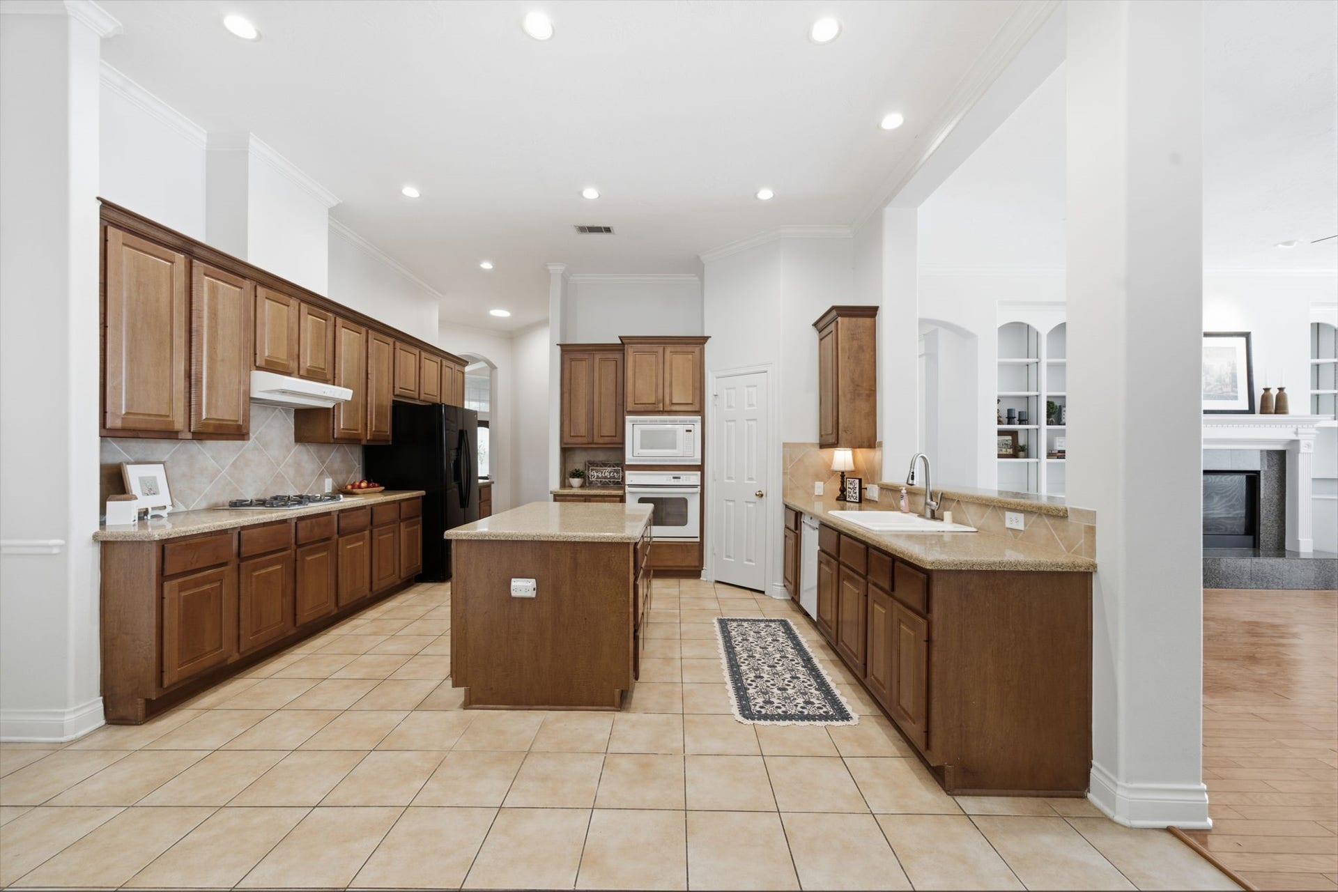 1227 Wellshire Drive, Katy, TX 77494 The large kitchen includes a walk in pantry, butlers plantry, large island with storage on both sides, gas cooktop and Kent Moore cabinets.